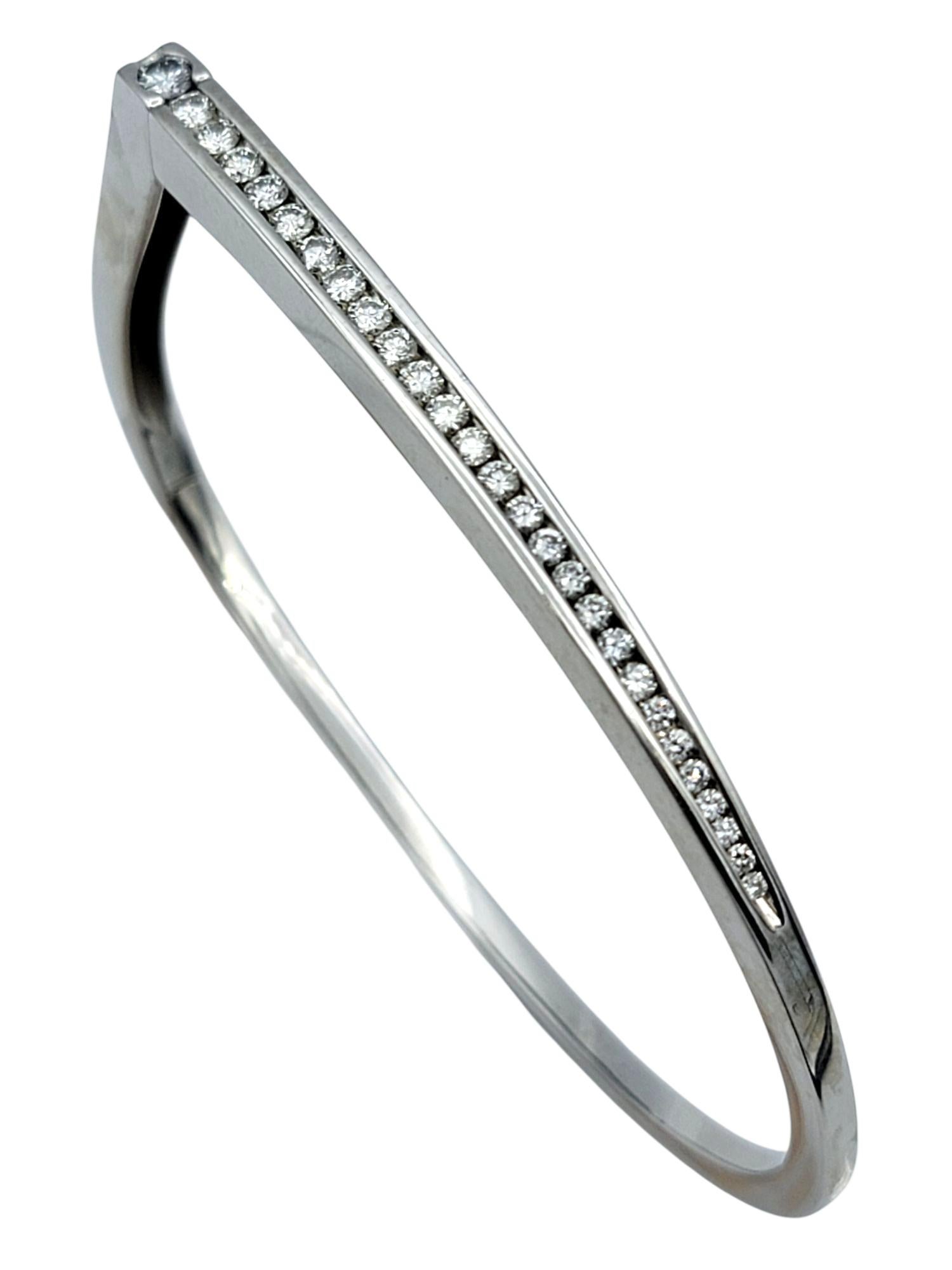 This elegant hinged bangle bracelet by Pascal Lacroix is a masterclass in refined minimalism. Crafted in 14 karat white gold, the sleek and sculptural form is elevated by a channel of round brilliant-cut diamonds, each precision-set for a clean,