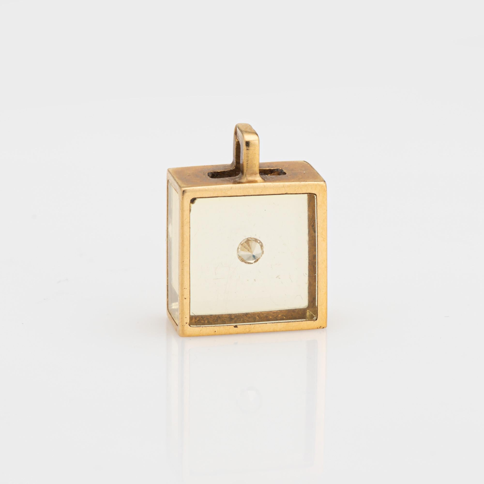 Finely detailed vintage French Pascal Morabito floating diamond cube pendant crafted in 18k yellow gold (circ 1970s).

One estimated 0.10 carat round brilliant cut diamond is set into the cube (set into resin or acrylic).  

The unique cube was