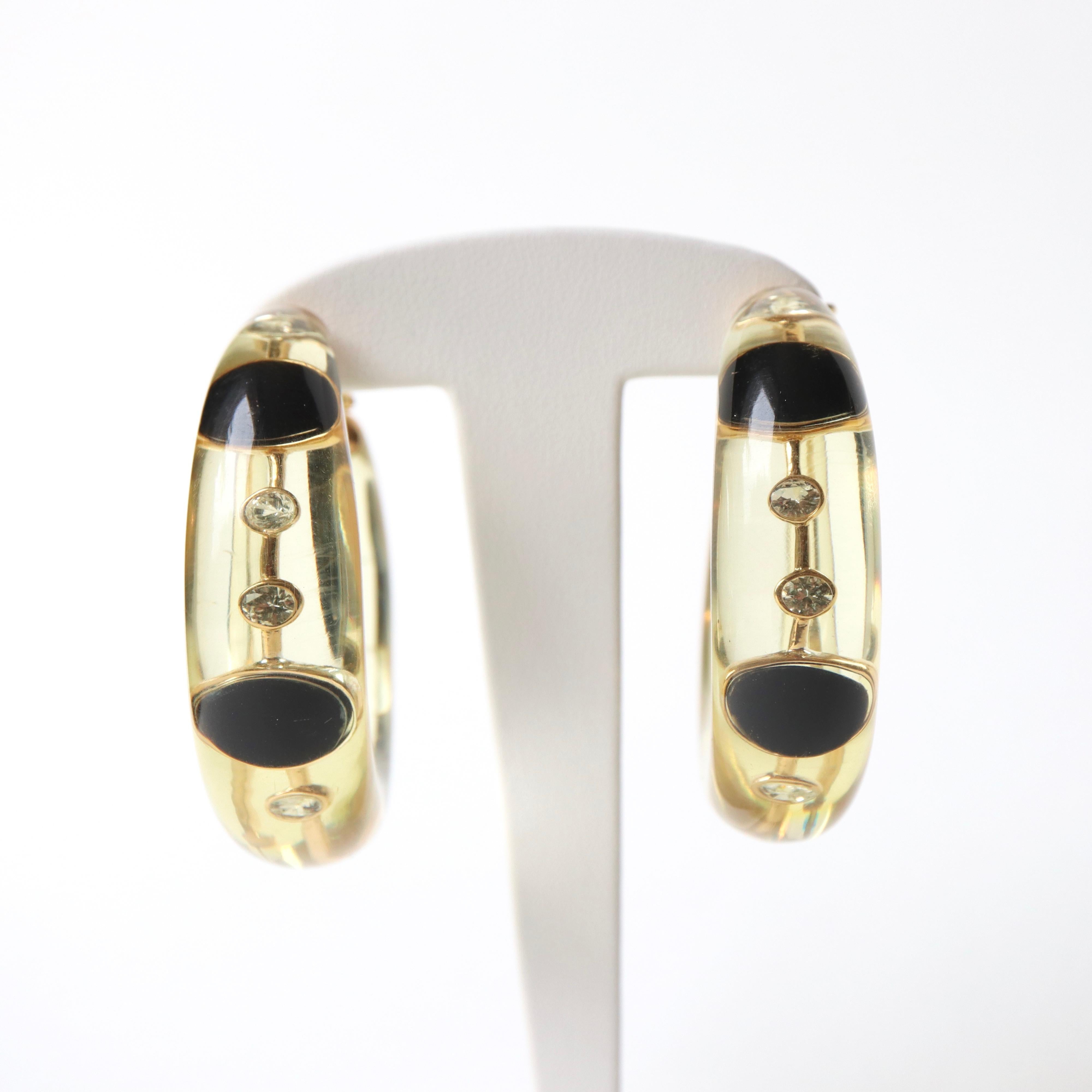 Pascal MORABITO Resin Hoop Earrings, 18K yellow Gold, Diamonds and Onyx Cast in transparent Resin.
Each Earring contains 4 Diamonds and 2 Onyx. Signed Pascal Morabito
Gross Weight: 58g Diameter: about 5cm