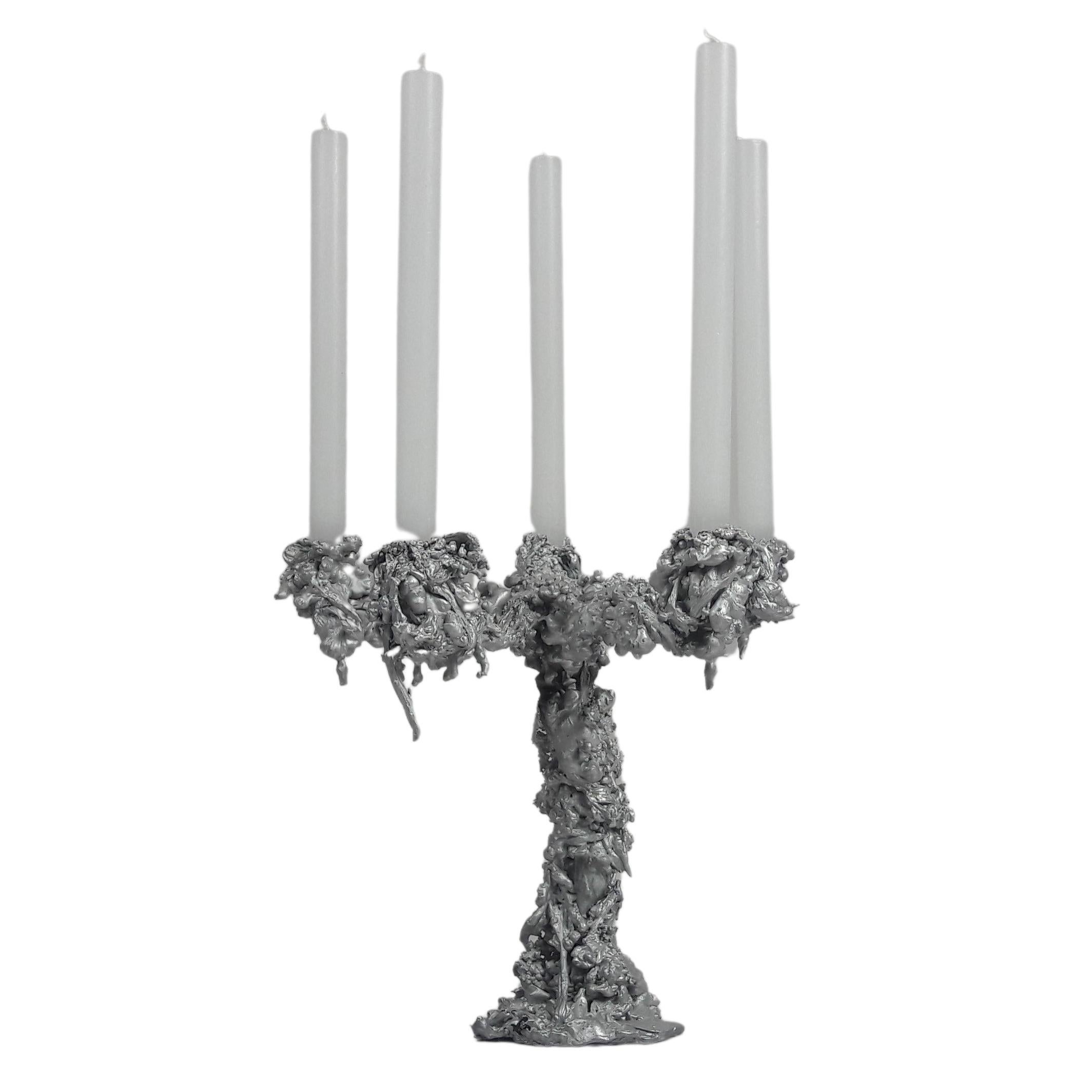 The upsidedown 5 armed aluminum candelabra is made in an edition of 10. This 'collectible design' objects contains a self-developed production method of hot wax solidifying in cold water, which makes every piece in this serie unique. The candelabra