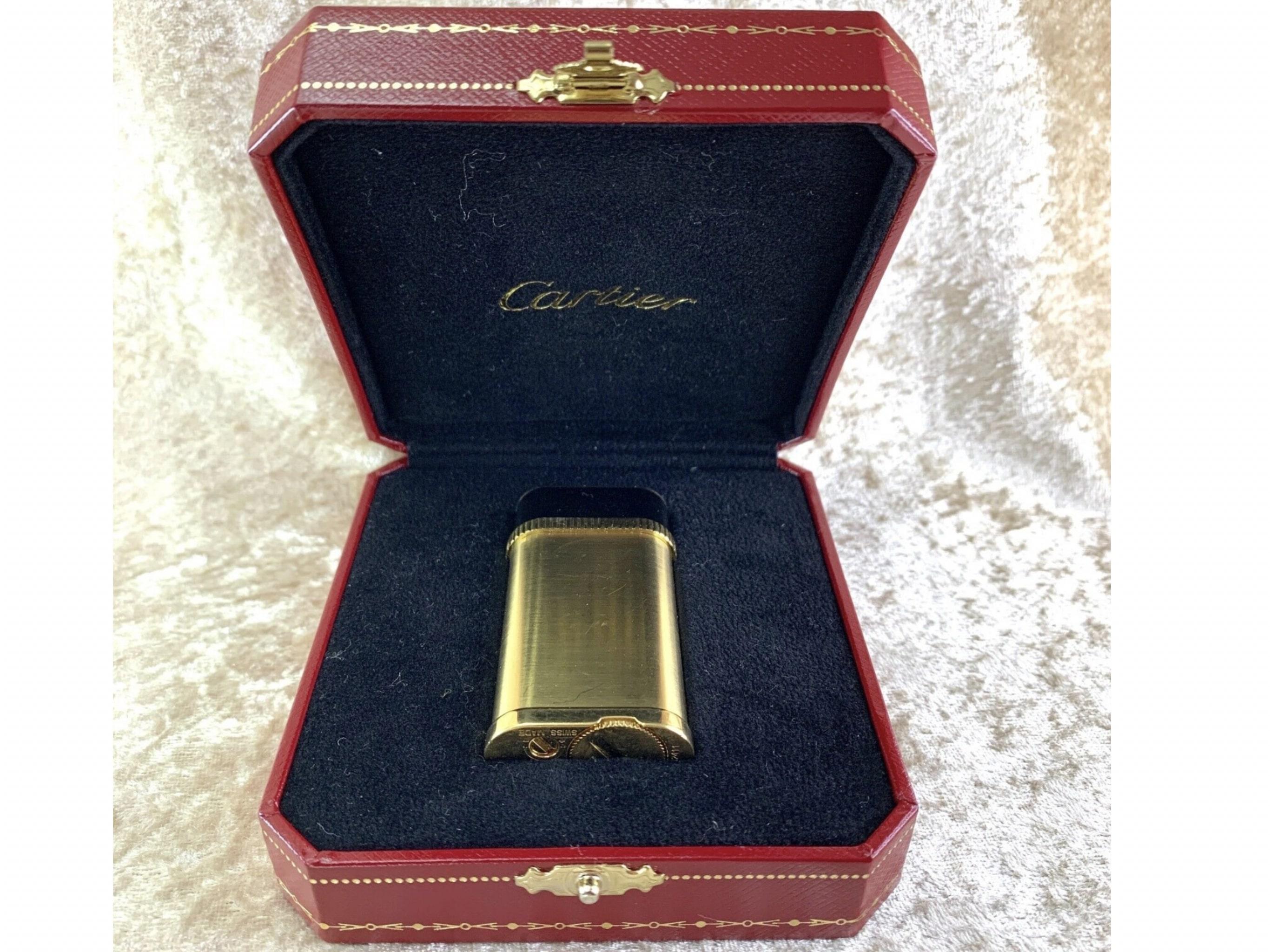Vintage Cartier Lighter
“Pasha de Cartier” Lighter Brushed 18K Gold Plate And Black Lacquer 
Comes with Original Cartier Case

Introduced in 1985, the Cartier Pasha collection was named in tribute to the Pasha of Marrakesh, who was a lifelong