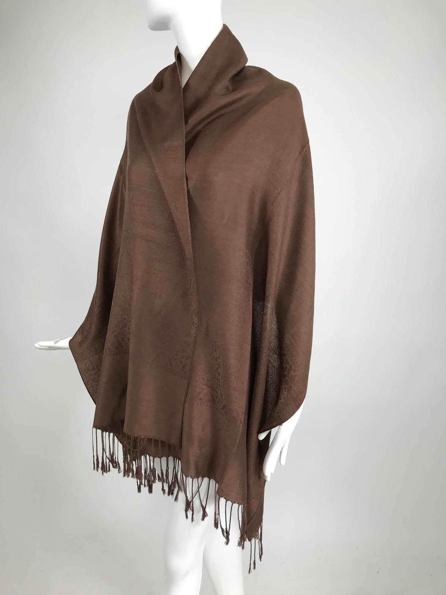 Pashmina and silk shawl in chocolate brown, it looks unworn. This beautiful shawl is woven in a classic paisley design. Wide and long it has knotted fringe on either end. In excellent condition.
Measurements are in inches:
Width 27
Length 75
Fringe