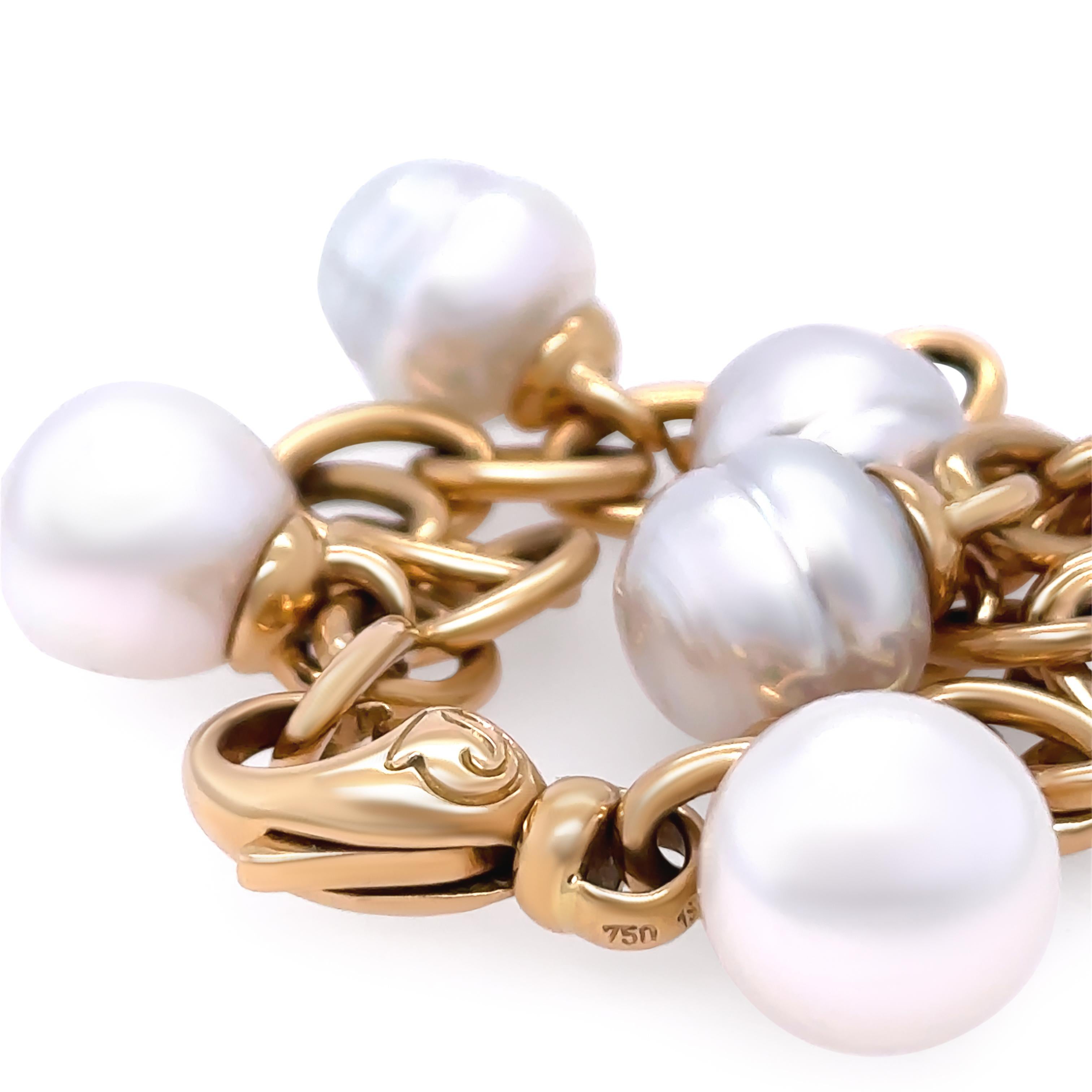 A Paspaley White South Sea Pearl Set Bracelet, made of 18ct Yellow Gold. Featuring 5 circle South Sea pearls suspended from the chain, each measuring 11mm in size, White Colour, Excellent Lustre, Light Blemish. Weight 37.5 grams, 20cm in