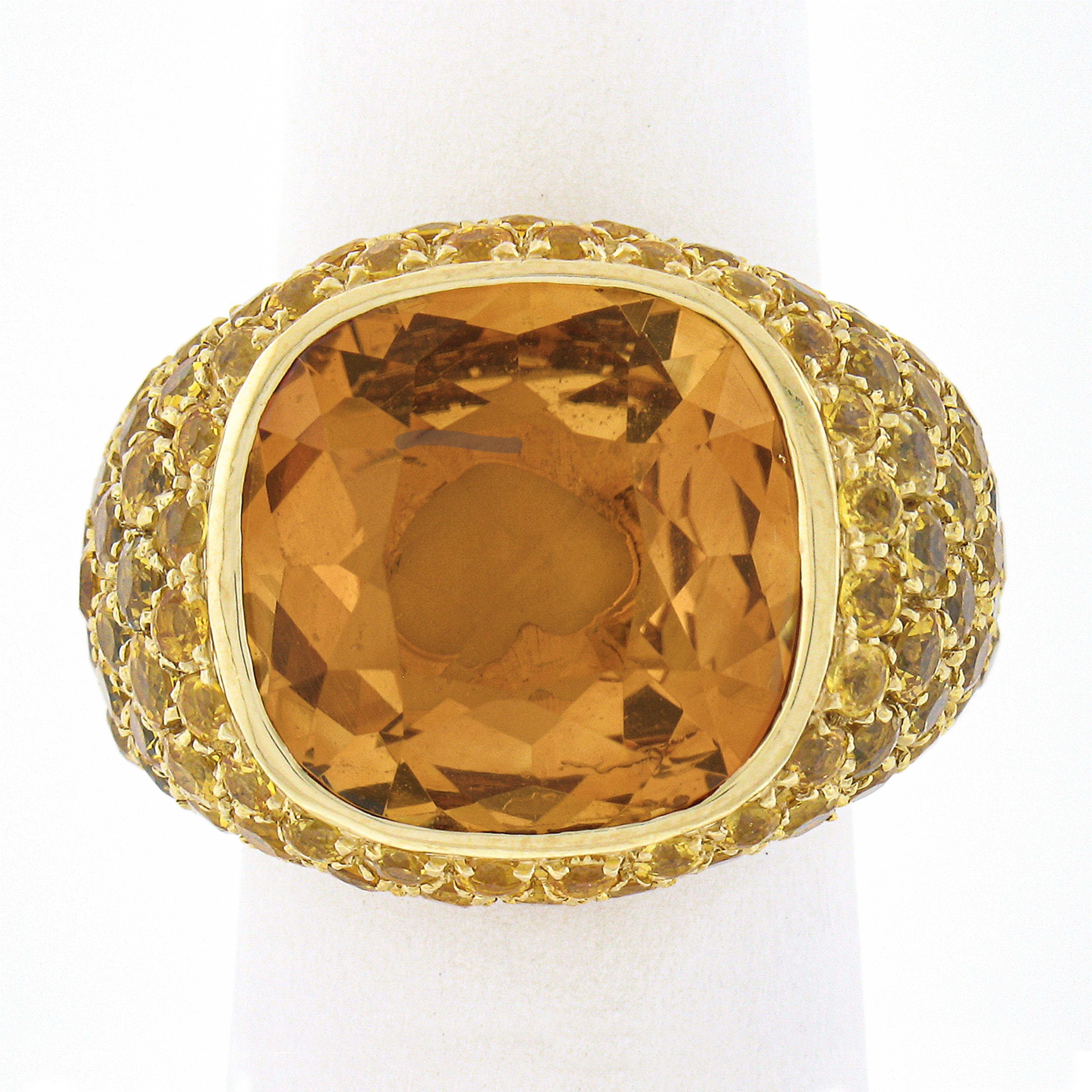 This stunning fancy cocktail ring is crafted in solid 18k yellow gold by Pasquale Bruni and features a large citrine stone bezel set at its center. This outstanding citrine shows amazing, absolutely rich orange color that gives a pleasant and truly