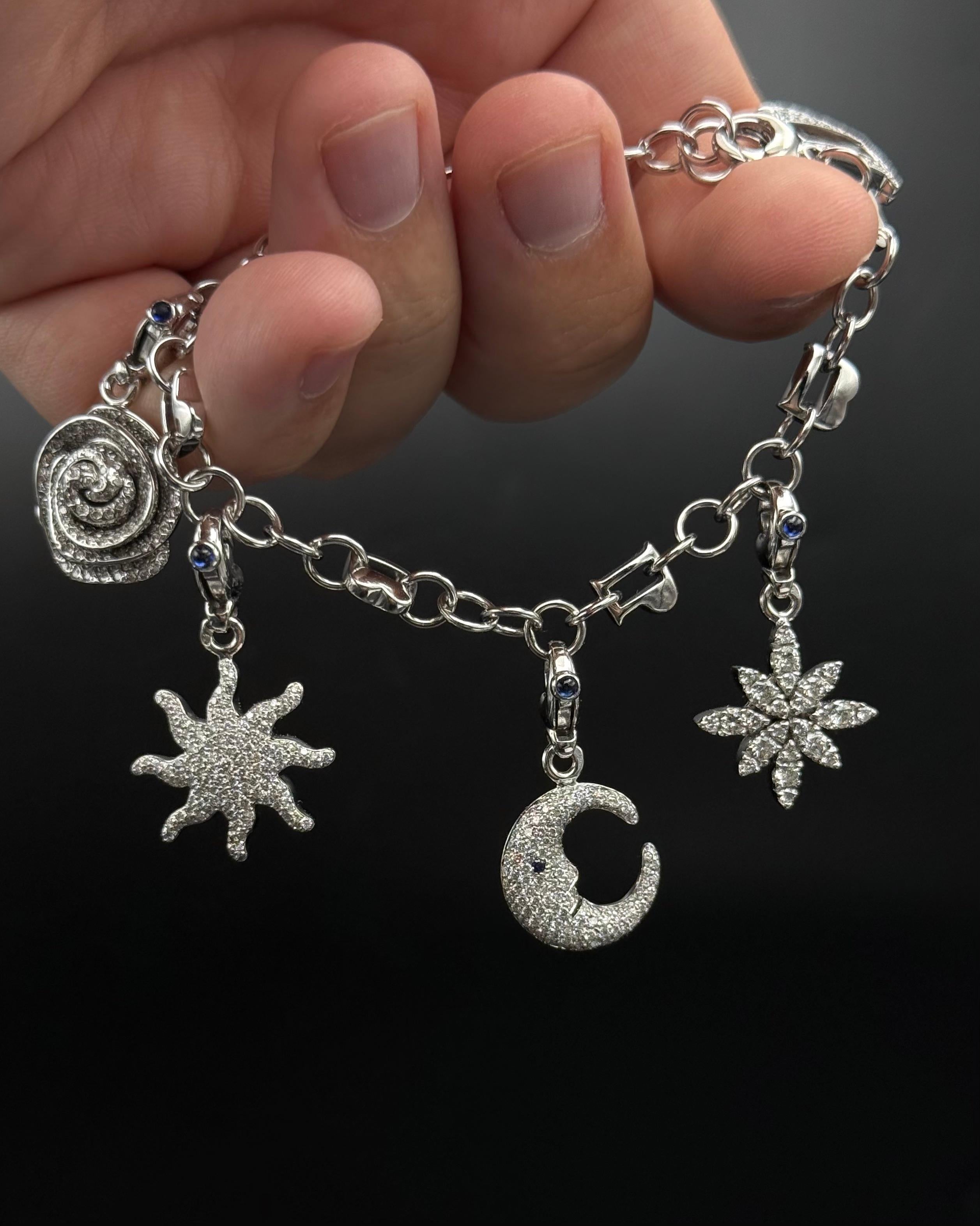 Pasquale Bruni Diamond Charm Bracelet in 18 Karat White Gold, Italy.

A whimsical and luxurious diamond charm bracelet by Pasquale Bruni, featuring five celestial and floral motifs symbolising light and harmony — a spiral rose, radiant sun, crescent