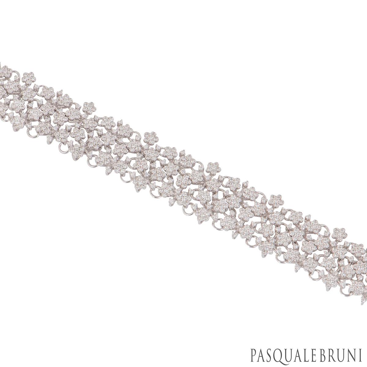 An 18k white gold suite by Pasquale Bruni from the Prata Fiorito collection. The suite consists of a pair of earrings, bracelet and necklace in an open work design set with flowers each individually set with 6 round brilliant cut diamonds. There are