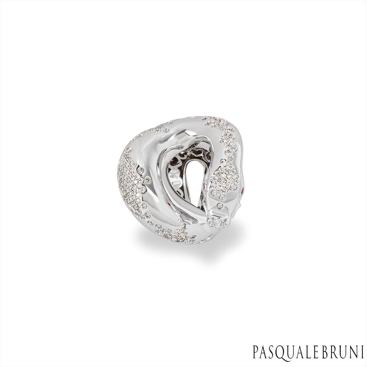 An enchanting 18k white gold diamond ring by Pasquale Bruni from the IL Peccato collection. The ring displays a snake motif that coils around the finger featuring 2 round ruby set eyes. Cascading down the back of the snake are 191 round brilliant