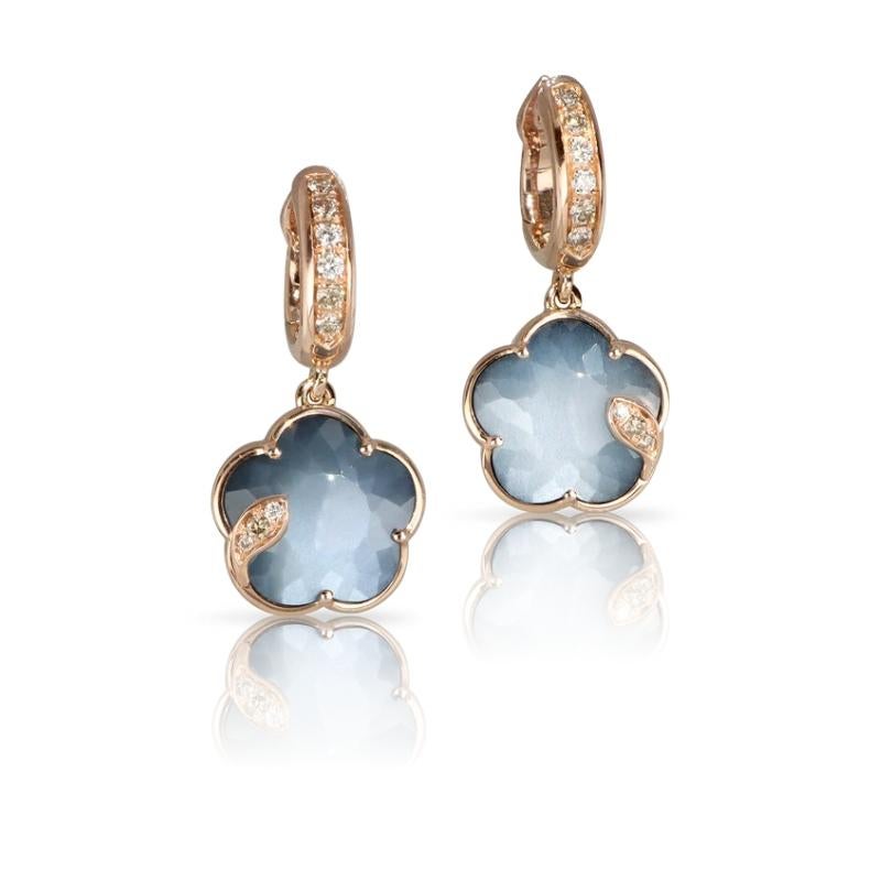 These Moonstone drop earrings from designer Pasquale Bruni make for an incredibly, earthy, every day wear. A mix of Onyx and Moonstone has created the blue hue on the center gem. The Stone is set in 18K Rose Gold and surrounded by diamonds.