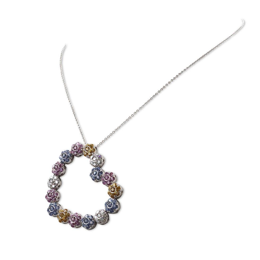 Authentic Pasquale Bruni necklace crafted in 18 karat white gold.  A charming heart-shaped pendant comprised of clusters of round-cut diamonds (approximately 1.25cttw), topaz (approximately 1.40cttw), and pink and yellow sapphires (approximately