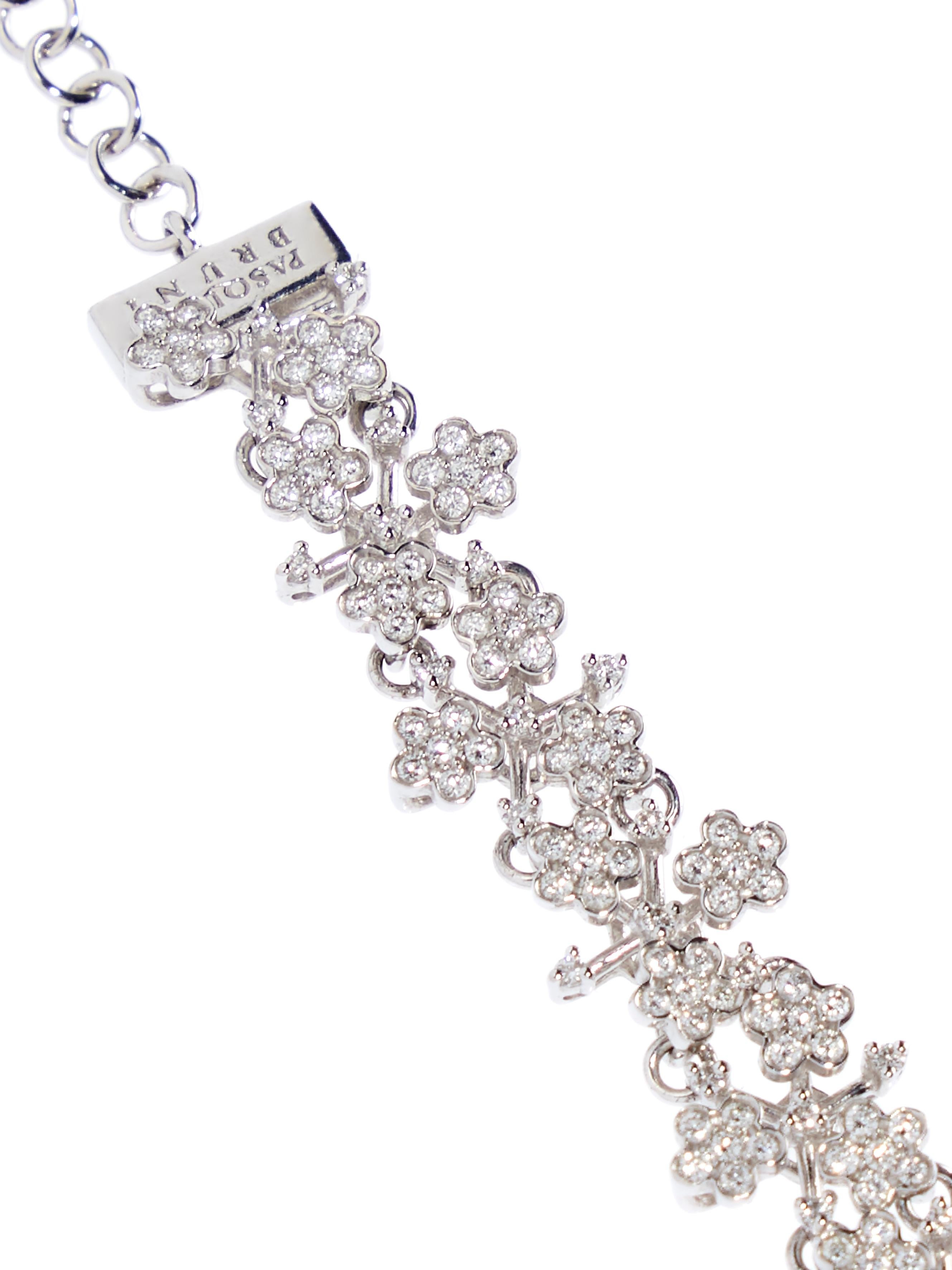 18 karat white gold bracelet in an open work design with flowers each individually set with 6 round brilliant cut diamonds, total 1.54 ct. Each little flower is linked to the next creating a flexible and comfortable to wear bracelet. The subtle