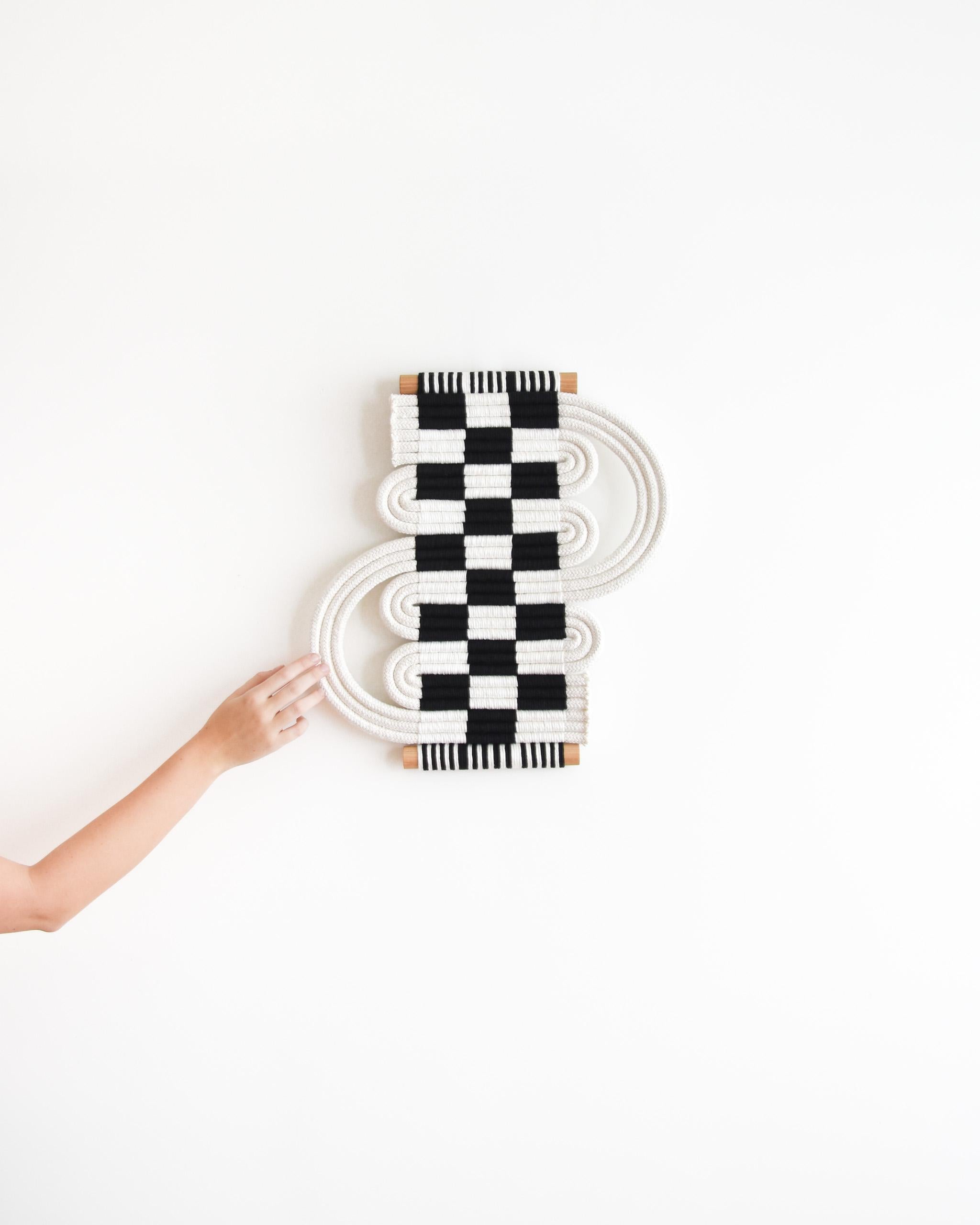 Hand knotted fiber art sculpture by Tamar Samplonius, inspired by the centuries old tradition of passementerie.


SIZE
- Width: 45 cm (18″)
- Height: 50 cm (20″)

MATERIALS
- Cotton cord
- Wooden dowel