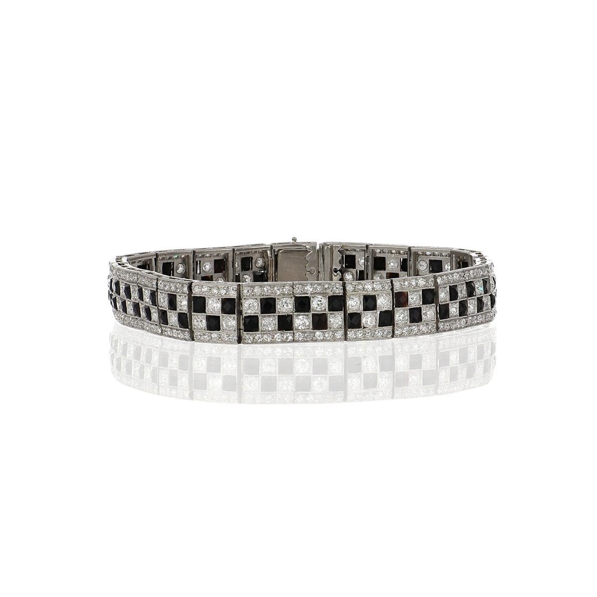 Art Deco platinum line bracelet, set with a checkerboard pattern of diamonds and onyx, with a pavé diamond edge. Circa 1920.  Bracelet contains Old European-cut and single-cut diamonds that total 6.72 carats, H-J color, and VS1-I1 clarity and
