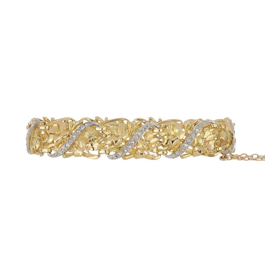 Belle Époque bracelet composed of 18K yellow gold openwork floral link bracelet, with rose-cut diamond accents set in platinum. Contains original safety chain. French, circa 1900.  Marks:  French mark for 18K gold.  