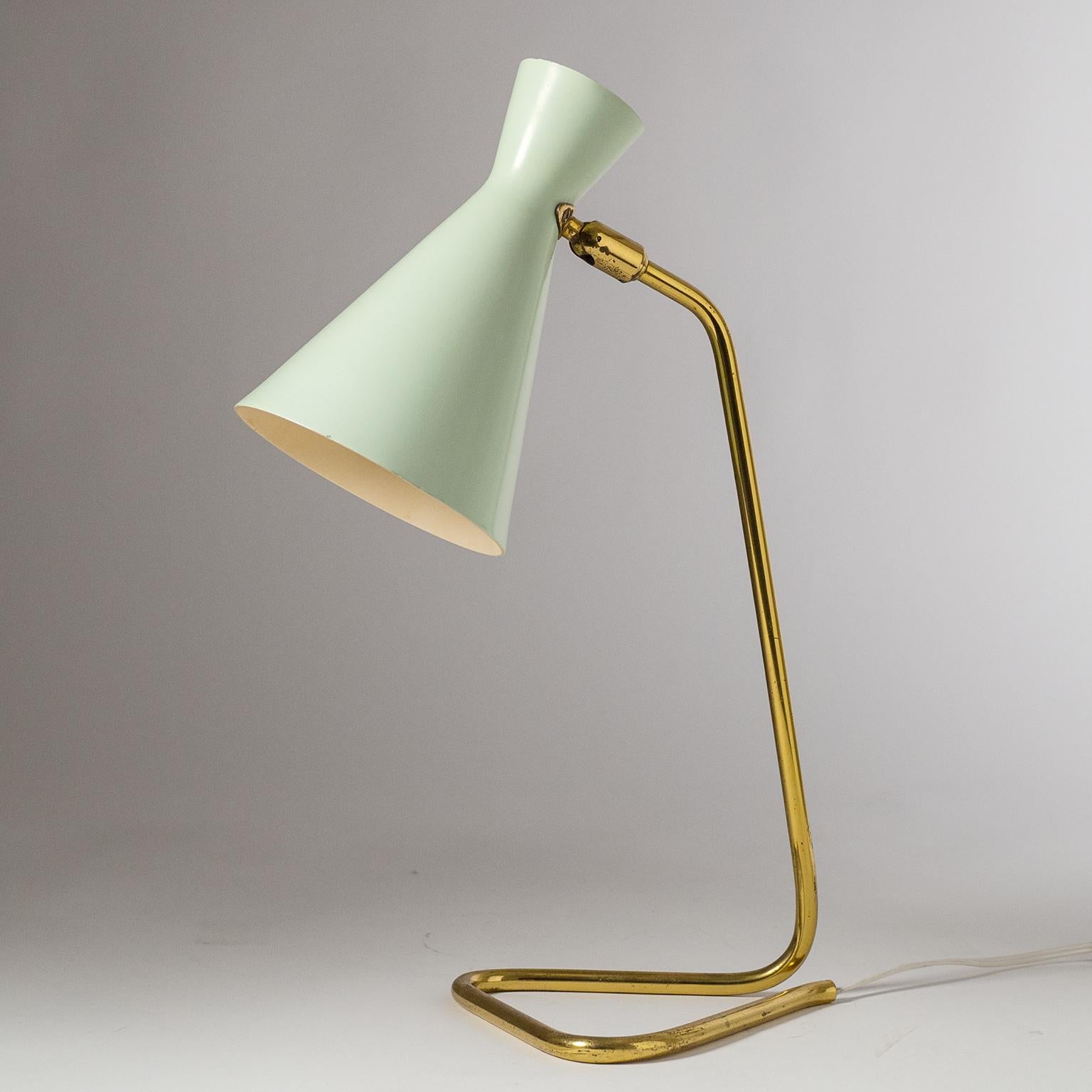 Beautiful mid century table or desk lamp by BAG Turgi, Switzerland, 1950s. The aluminum double cone shade has its original paint which is in very good condition: a very light mint on the outside and a pale peach on the inside which casts a warm and