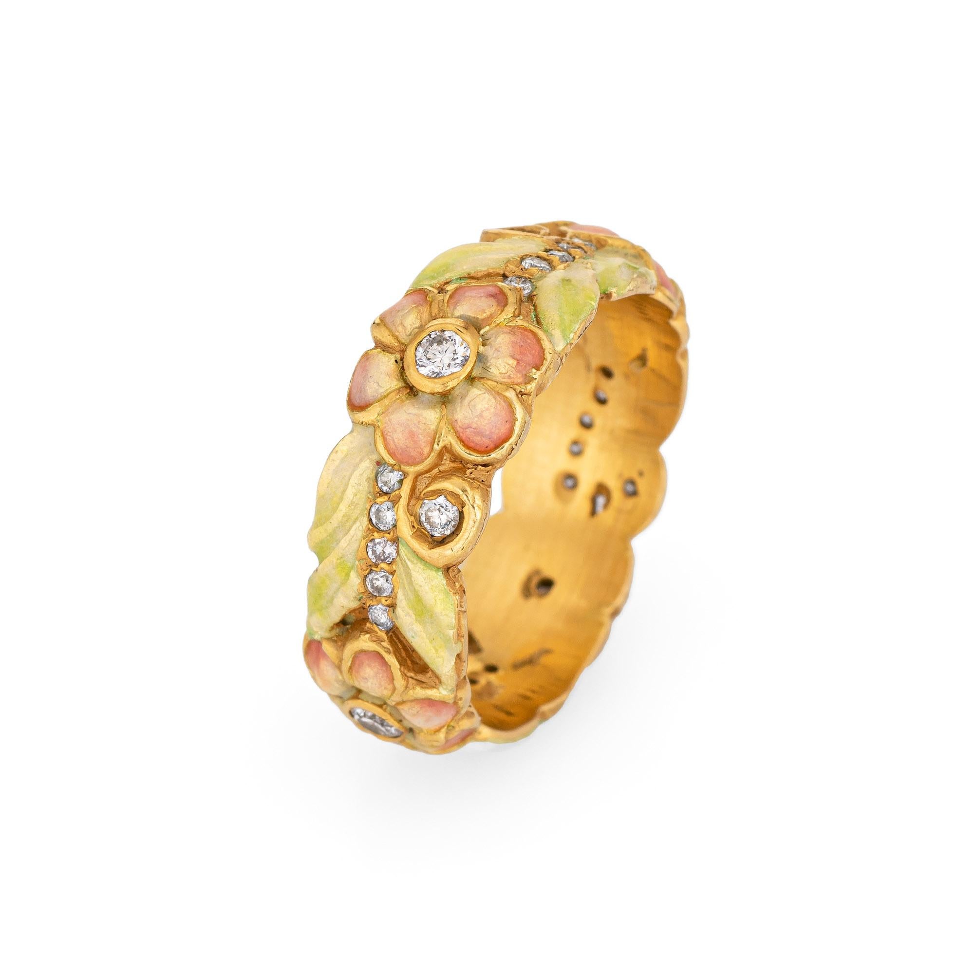 Elegant vintage enameled flower eternity ring crafted in 18 karat yellow gold. 

Diamonds total an estimated 0.40 carats (estimated at H-I color and VS2-SI1 clarity).   

The beautifully detailed ring features green and pink pastel colored enamel,