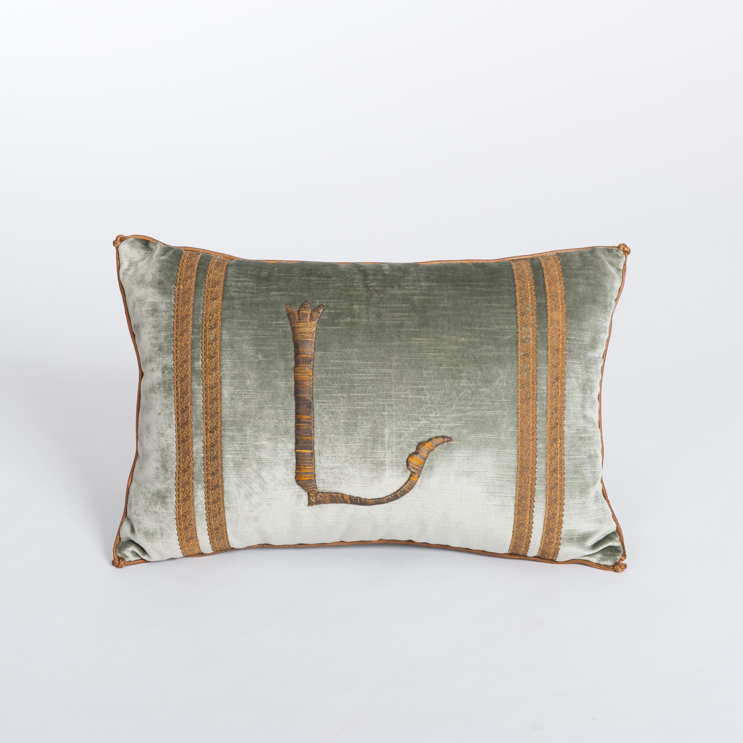 A down-filled single pillow fabricated with a 19th century raised gold metallic
embroidery of the letter 