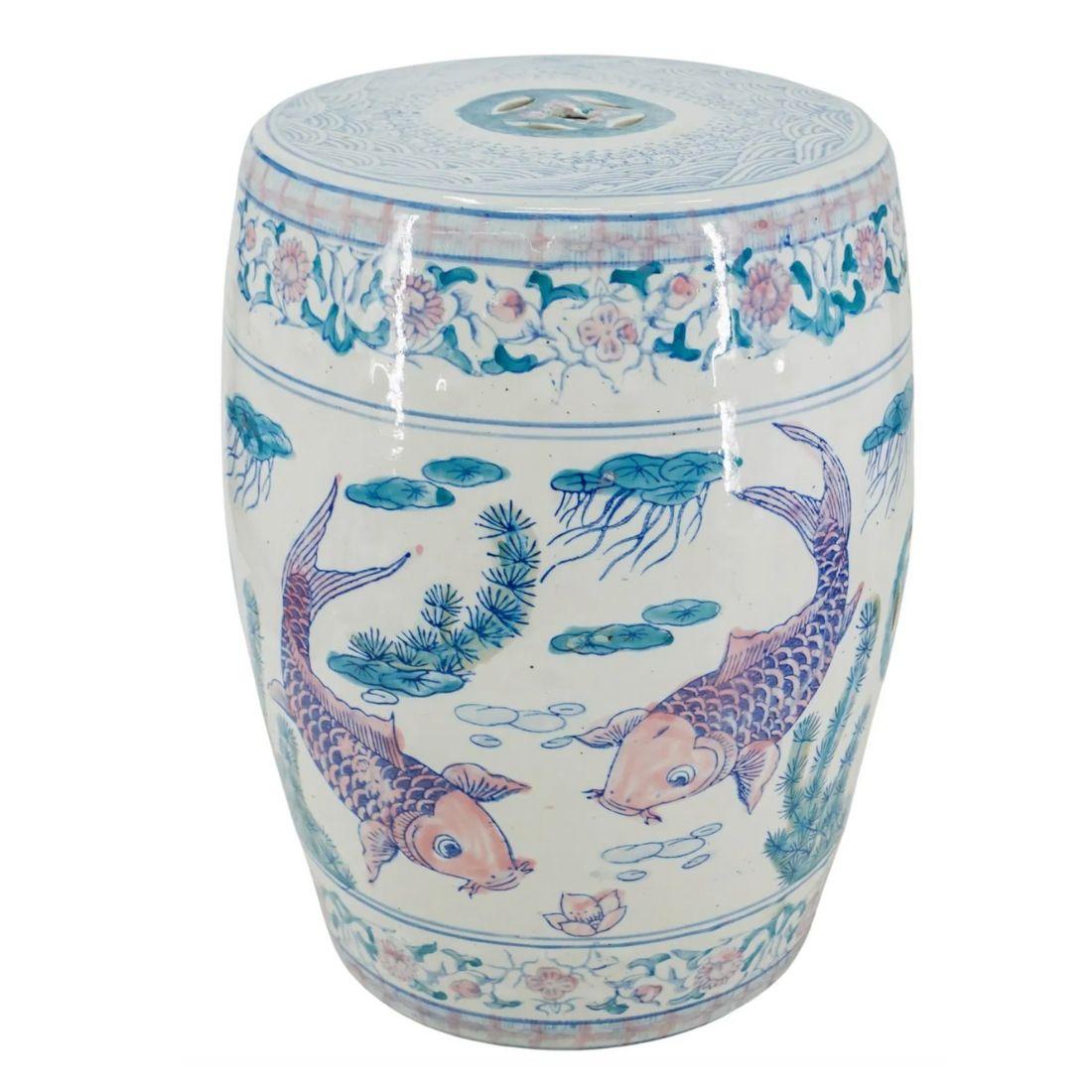 The Pastel Koi Chinese Garden Stool is a beautifully crafted ceramic piece featuring delicate koi fish motifs, symbolizing prosperity and good fortune in Chinese culture. The stool is adorned with soft pastel hues, creating a serene and elegant