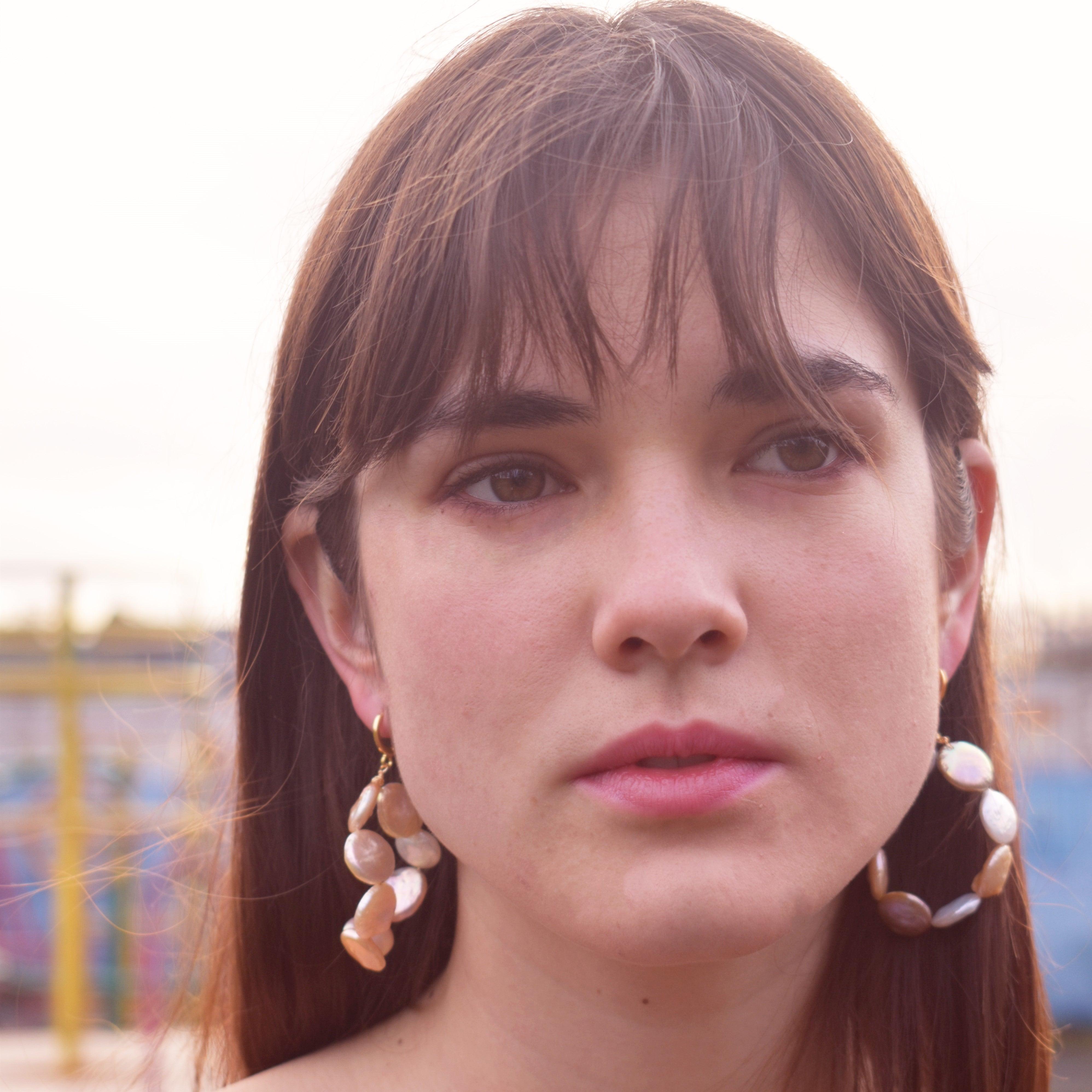 These hoop earrings are an unusual play with pearls. The beautiful nautral pastel freshwater pearls are so delicate and elegant. A unique array of coin pearls to get the most effortless shimmer on your ears .

DETAILS
Brand: Ifemi Jewels
Finding: