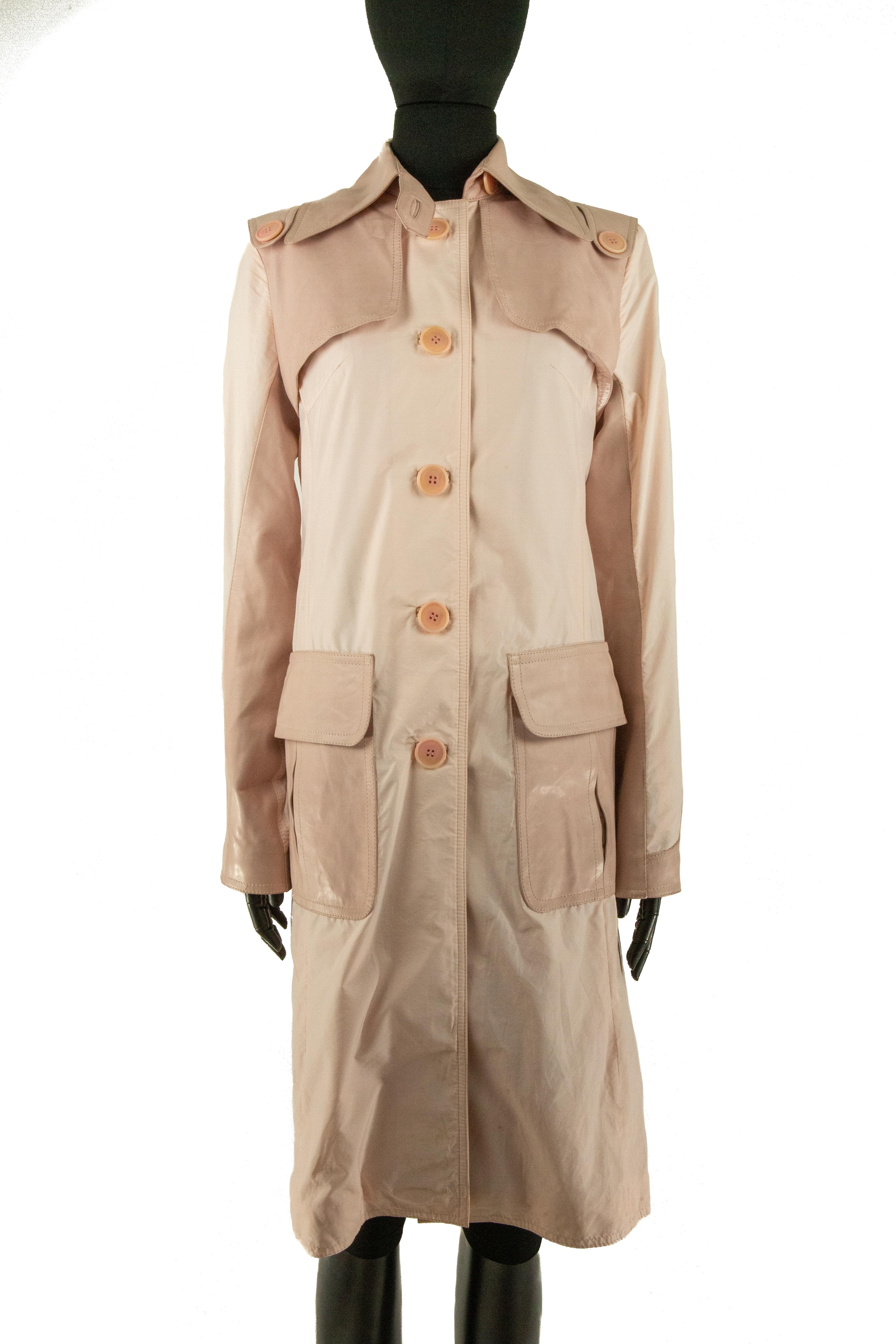 A pastel pink Jitrois coat made from acetate and panels of pink leather. This coat is single-breasted with buttons embossed with ‘Jitrois’ that starts just above the hips and continue to the collar where there’s a strap that can be buttoned up