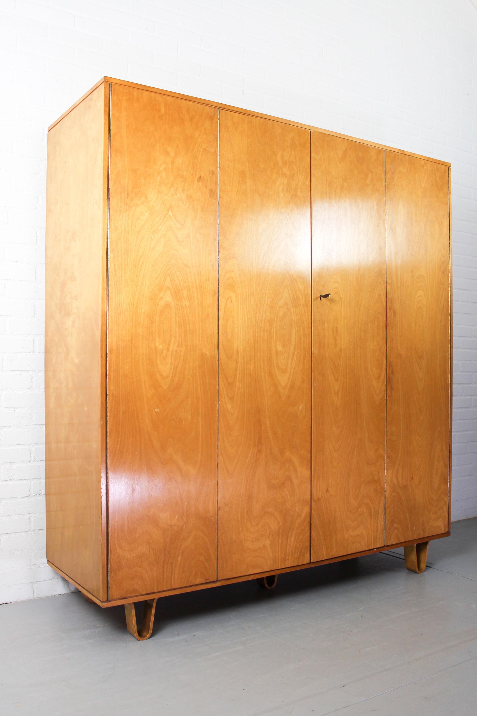Large Pastoe wardrobe KB04 with the trademarks bent plywood legs designed by Cees Braakman for Pastoe, with all original interior; Shelves, bent plywood drawer, bent plywood shelf and mirror.
  