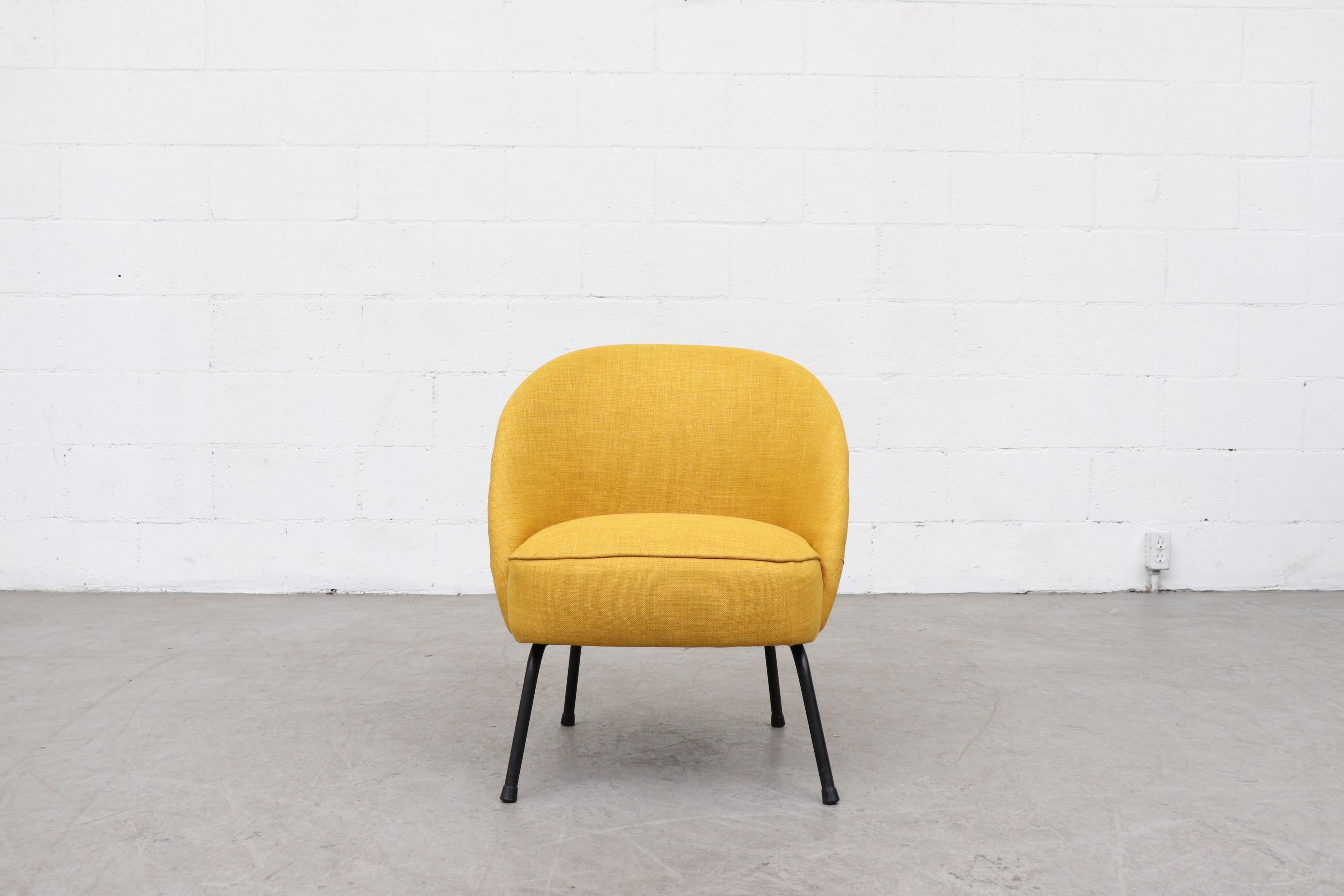 Sweet little chair in new sunshine yellow upholstery with black enameled metal legs. Small stature, frame in original condition with some signs of wear.