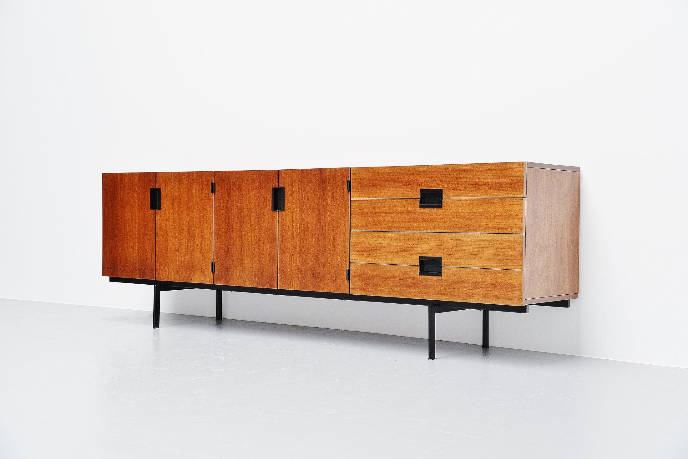 This is for a sideboard model DU03, designed by Cees Braakman and manufactured by Pastoe UMS, Holland, 1958. This sideboard is made of teak wood and has a black lacquered metal frame. The handles are made of black plastic. This sideboard is from the