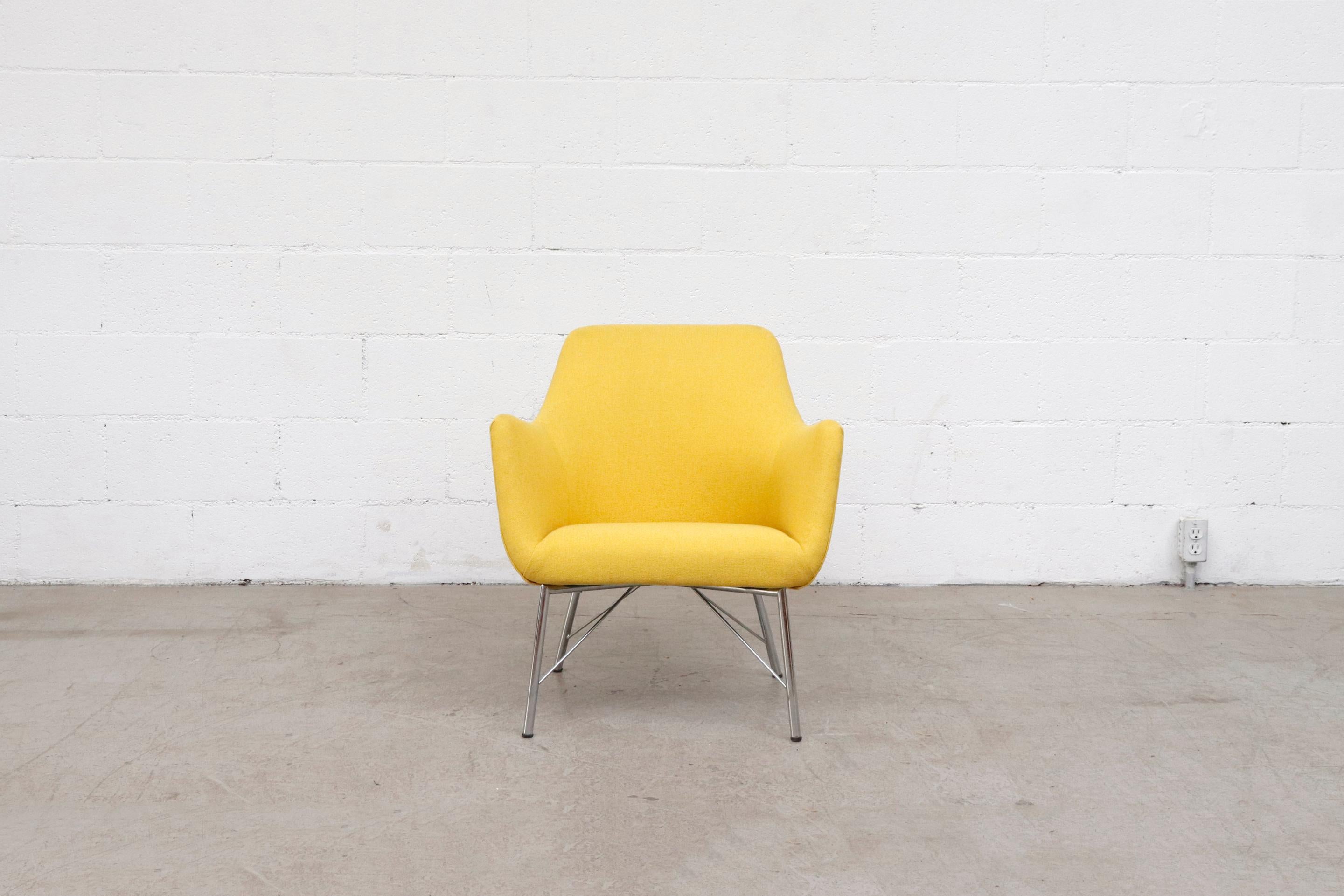 Newly re-upholstered in canary yellow fabric with original architectural chrome base. Frame is in original condition with signs of wear consistent with its age and use.