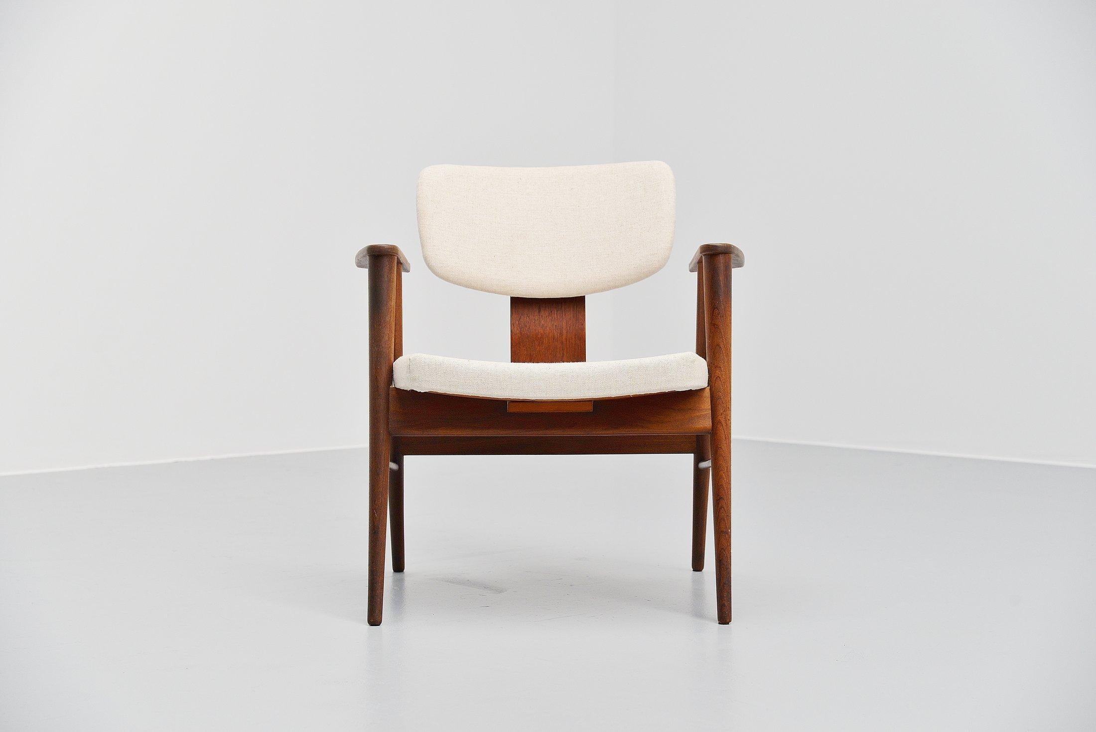 Very nice armchair model FB14 designed by Cees Braakman and manufactured by Pastoe, Holland 1956. The chair has a solid teak wooden frame and is newly upholstered in a nice cream linen upholstery. The chair has nice plywood armrests and seats very