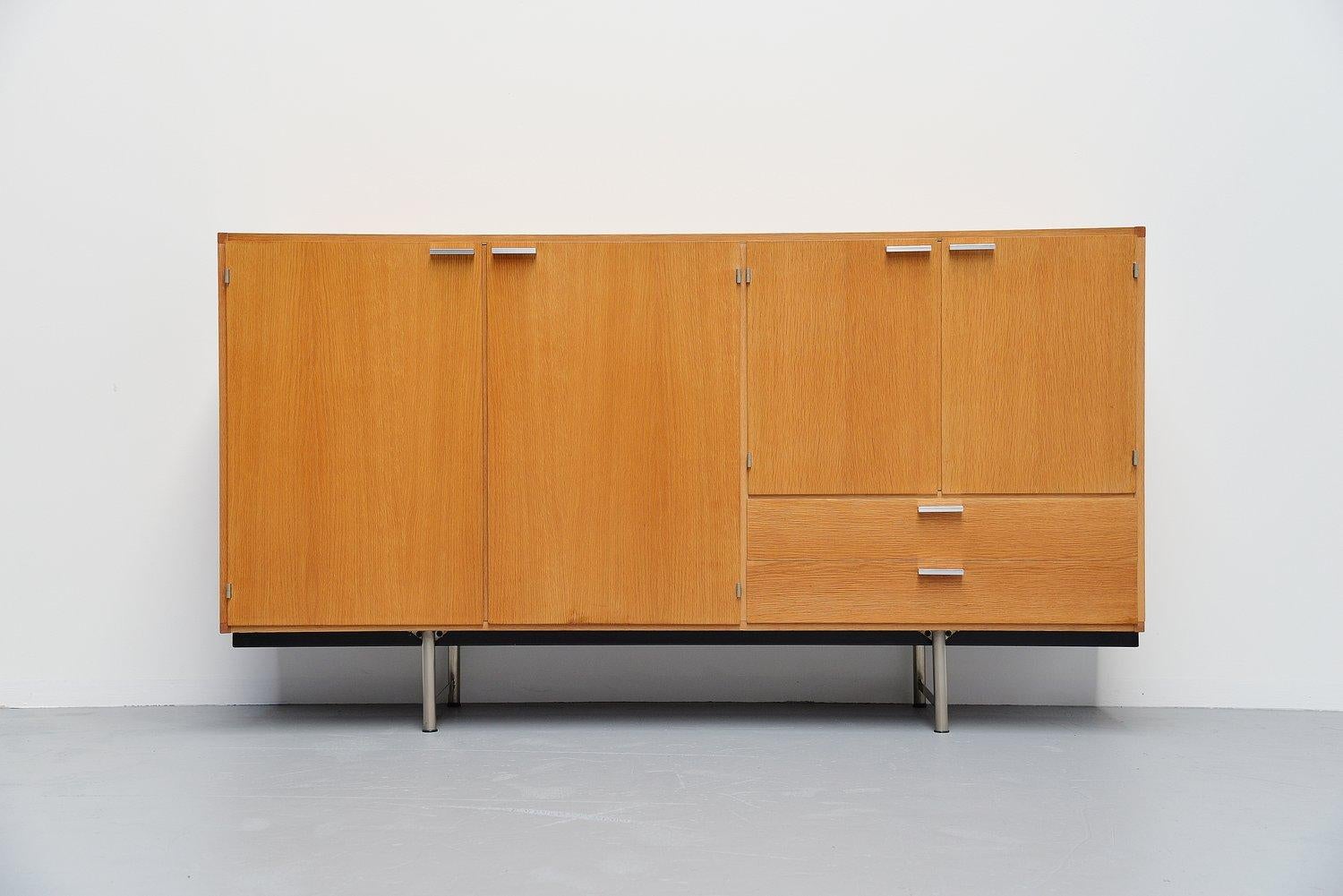 Fantastic grained buffet from the made to measure series designed by Cees Braakman for Pastoe, Holland, 1965. This oak veneered buffet has a nice and warm color wood. It has solid aluminium handles and a chrome plated metal base. This buffet