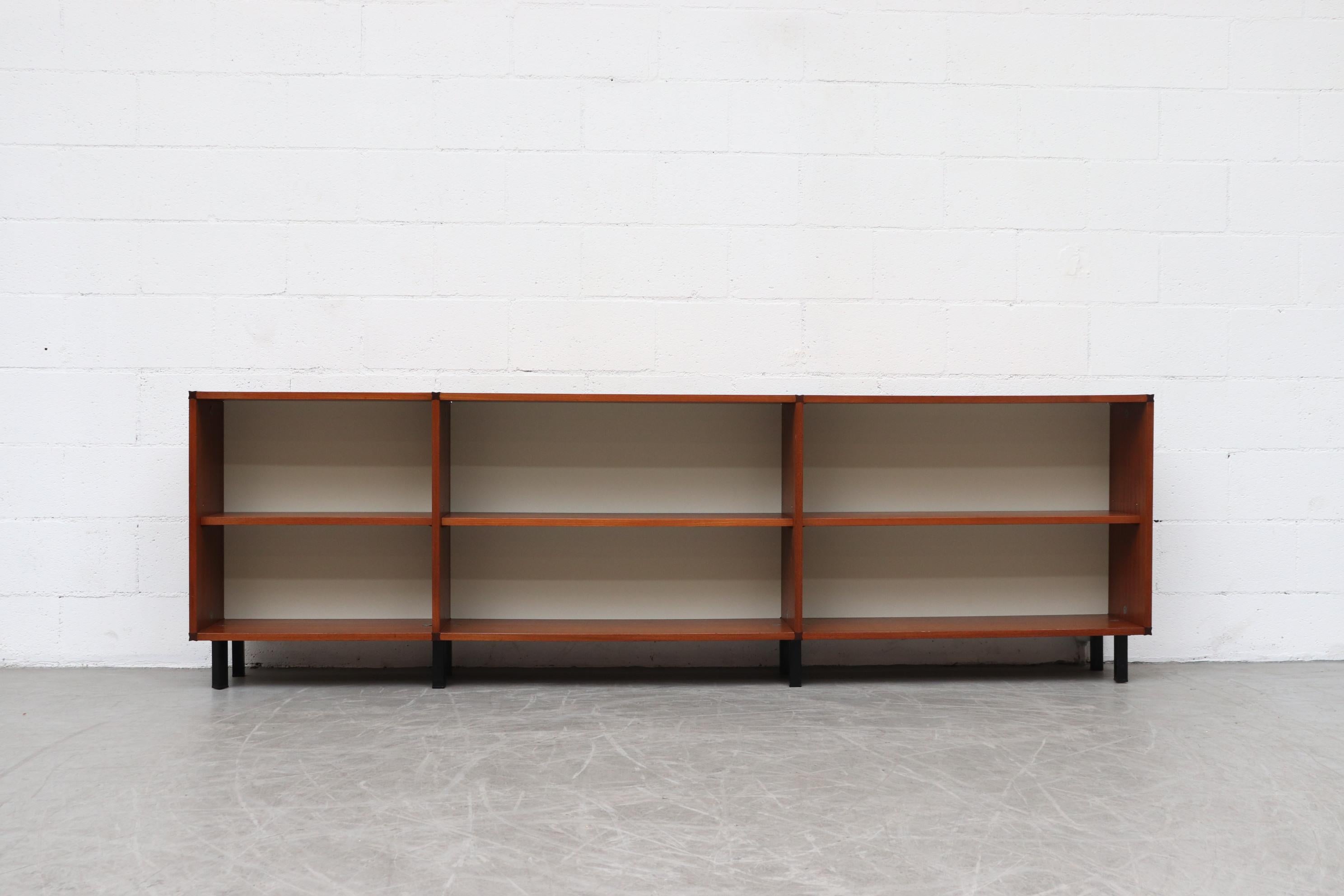Pastoe 'Made to Measure' 3-section teak bookshelf with melamine backing and black enameled metal legs. Lightly refinished. In original condition with wear consistent with its age and use.