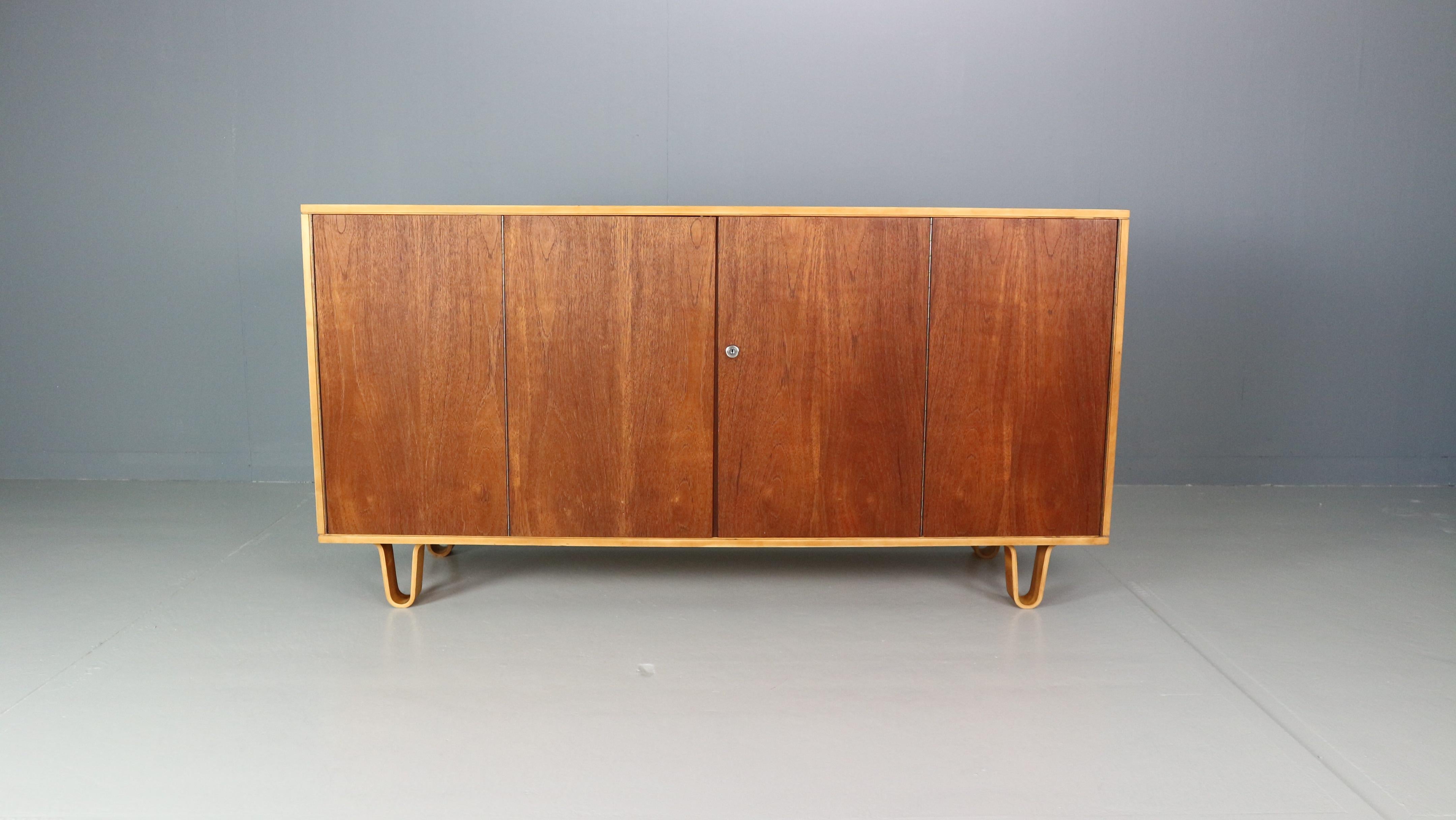 Modernist sideboard model DB02 designed by Cees Braakman, manufactured by Pastoe UMS, Holland 1952. This sideboard has a double folding door with 3 shelves and 4 drawers behind. This sideboard is from the famous birch series by Cees Braakman who
