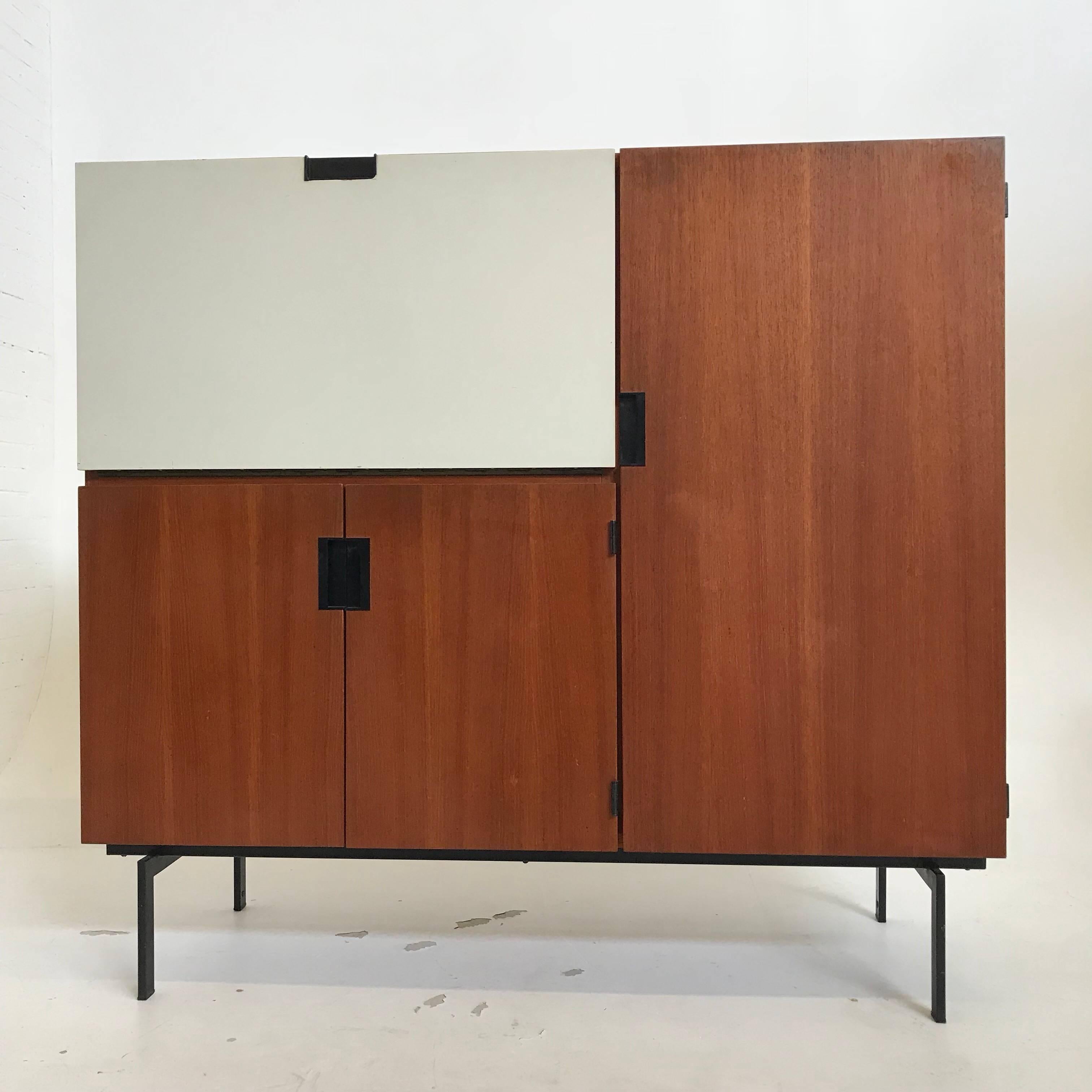 Beautiful CU-06 'Japanese Series' cabinet / buffet / desk by Cees Braakman for Pastoe. The interior behind the drop down door can be used as a writing desk or a liquor cabinet. The large door has shelves and a small (rare) extra two-drawer cabinet