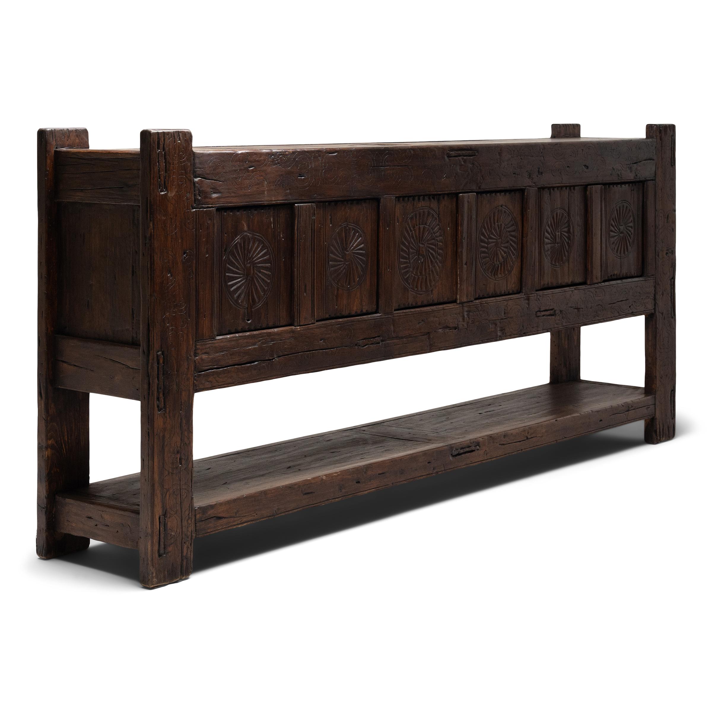 This rustic six-door coffer from the early 20th century balances modern simplicity with humble, timeworn materials. Attributed to artisans of Xinjiang province in Western China, the sideboard is crafted of pine with mortise-and-tenon joinery and