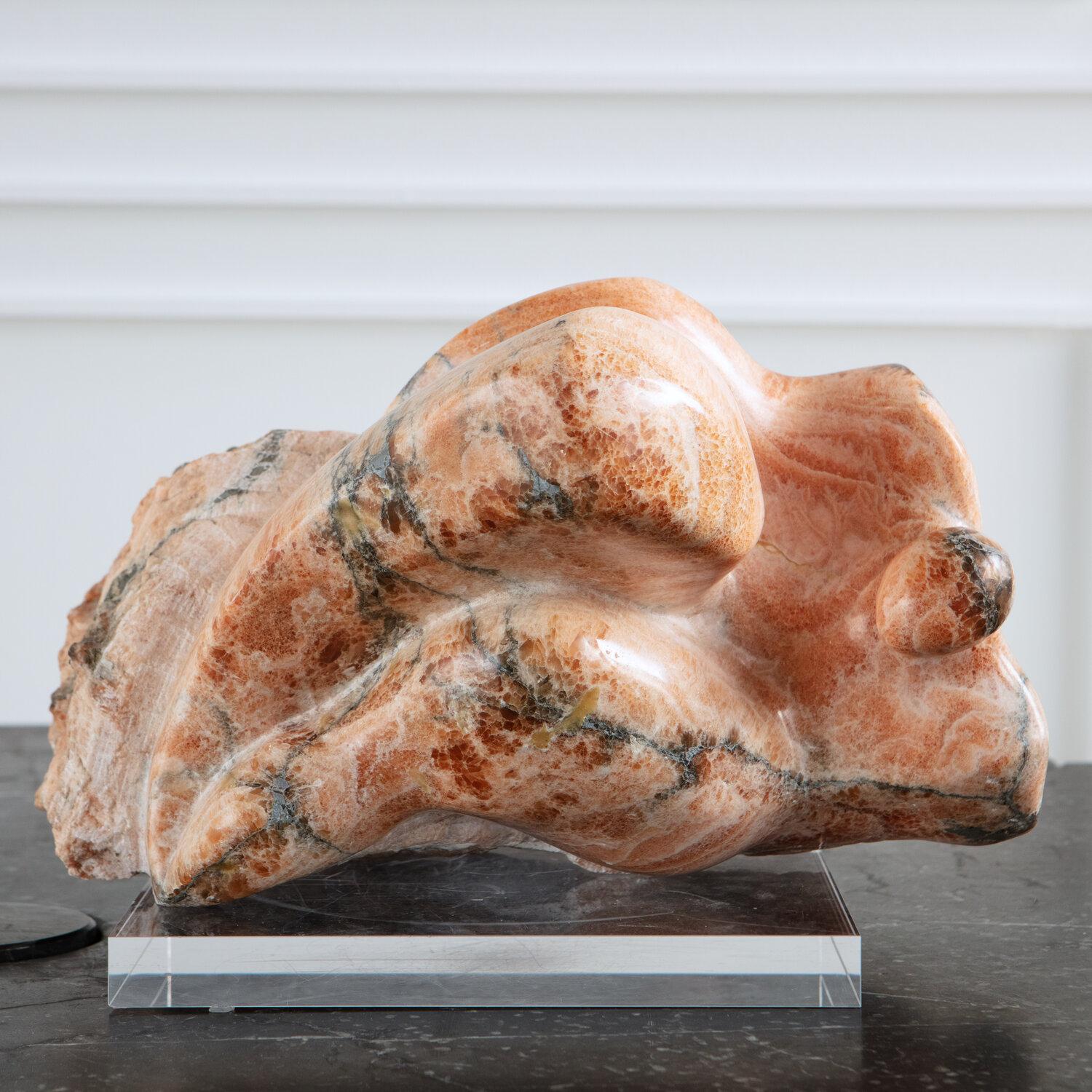 A gorgeous marble sculpture abstractly depicting a reclining figure. Signed 