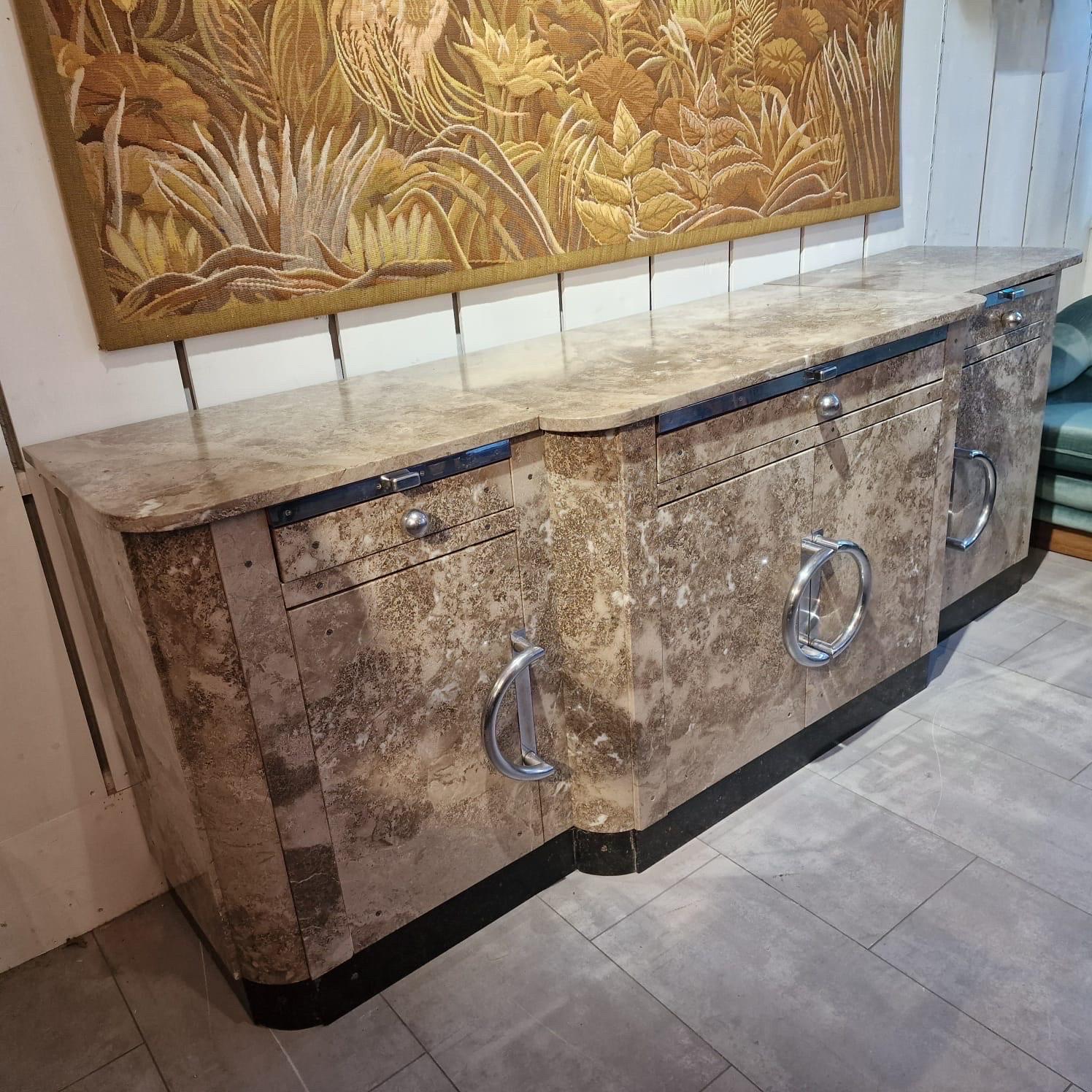 Exceptional art deco period marble credenza coming from a French pastry store.
4 doors, 3 drawers and big chrome handles. Too divided in 3 parts, wooden shelves inside. Black marble base.
Very good overall condition (only 3 cracks see photos).