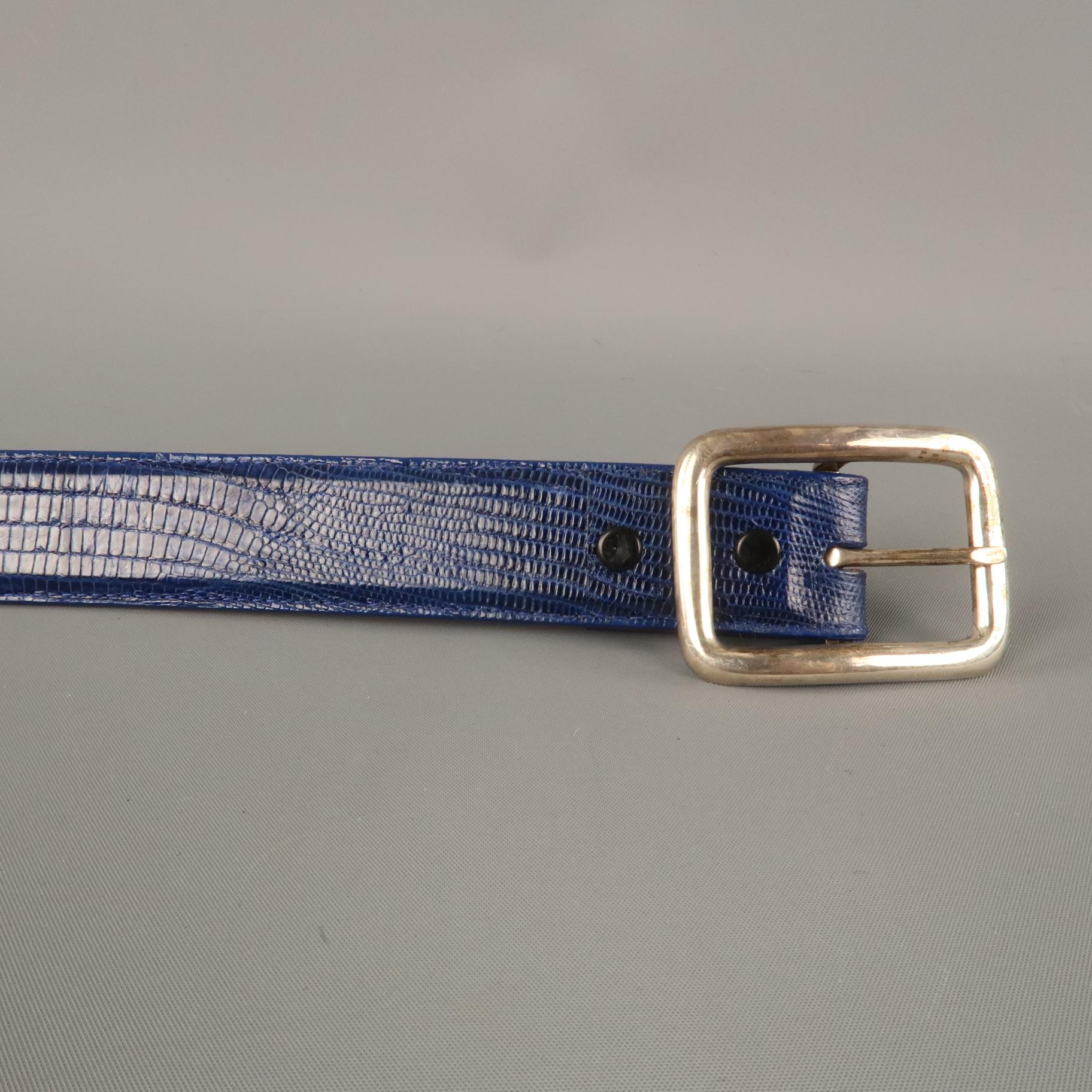 PAT AREIAS  belt comes in a royal blue lizard textured leather featuring a silver tone metal buckle. Made in USA.  

Excellent Pre-Owned Condition.
Marked: 34

Measurements:
Length: 40.5 in.
Width: 1.2 in.
Fits: 32.5 - 36.5 in.