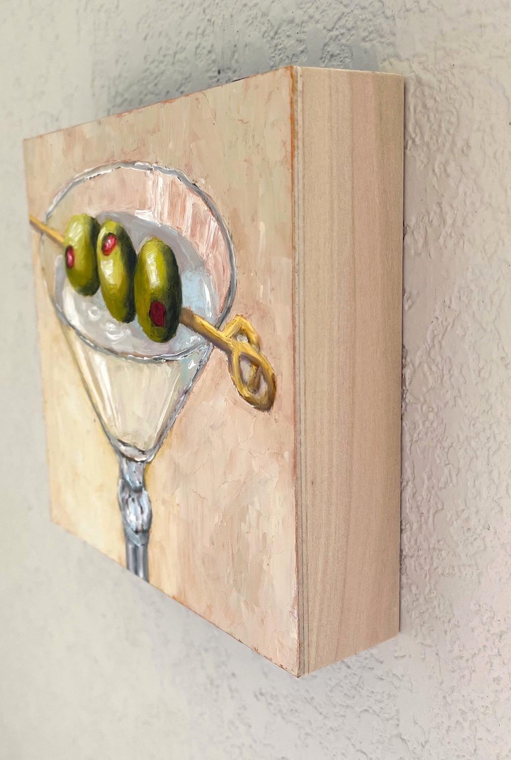 <p>Artist Comments<br>A sophisticated martini stands against a neutral background. Vivid green olives on a skewer rest on the rim of a sleek glass and add a pop of color to the concoction. The artwork emphasizes a harmonious composition while