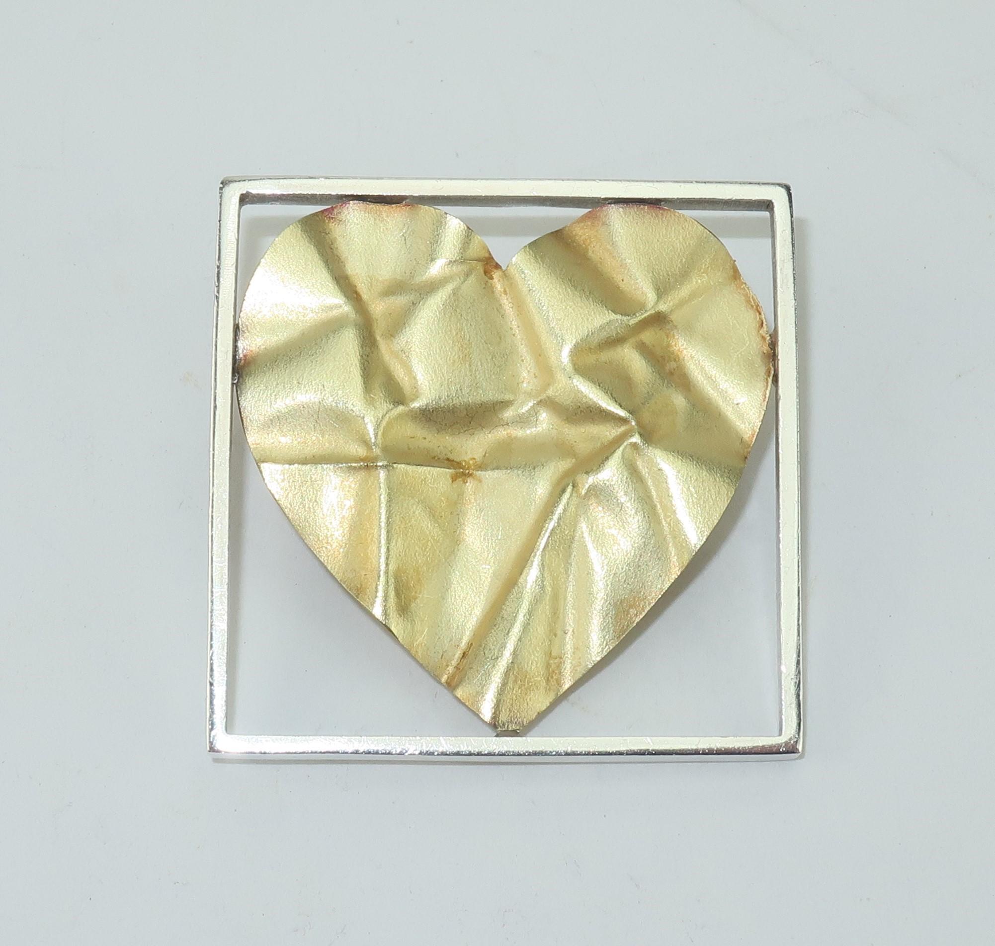 The crumpled heart tells a story as Pat Flynn, New York goldsmith, intended with his iconic contemporary design.  Mr. Flynn's hearts have been a constant in his repertoire of modernist jewelry and this sterling silver and 18K gold 'crumpled' heart