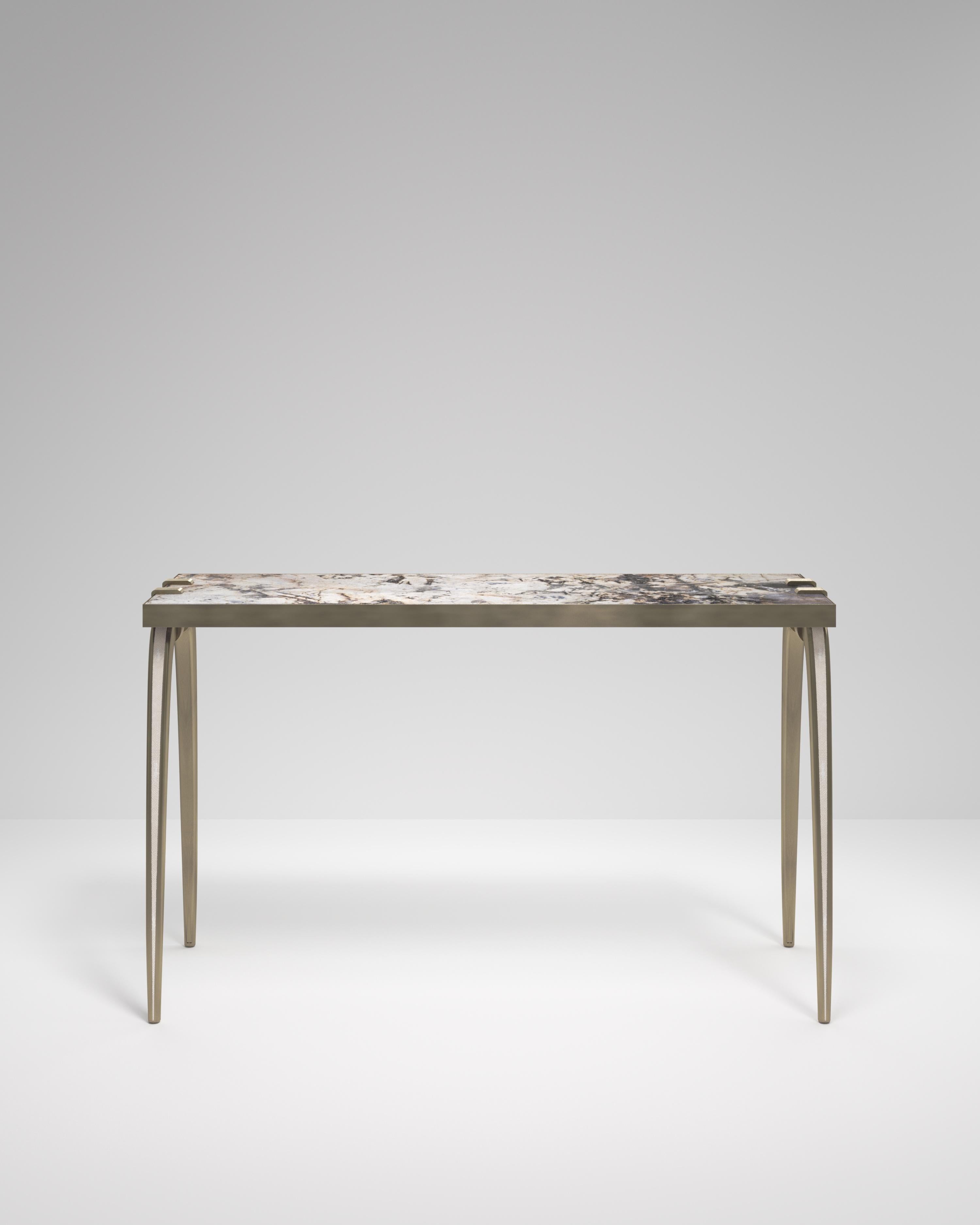 The Sonia Console table is an iconic Augousti design, showcasing the exquisite craftmanship behind the brand. The shagreen inlaid legs clasp onto the side of the patagonia rectangle top. This piece is a nod to the Art-Deco period while remaining