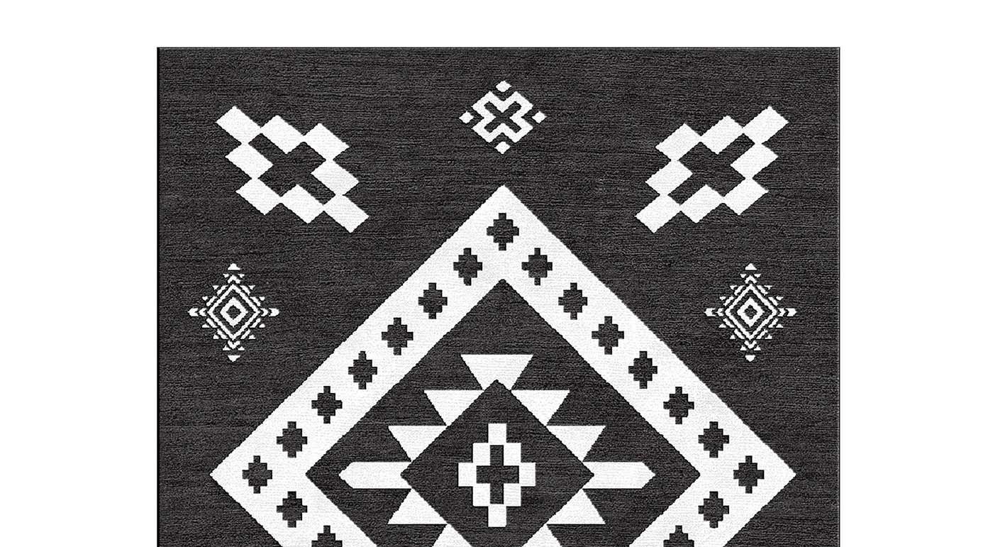 Part of the Limited Edition collection, this superb rug is designed by Marcelo Burlon and features a geometric pattern with a series of white elements on a black background, reminiscent of the Ikat decorations. Hand-knotted by expert artisans in