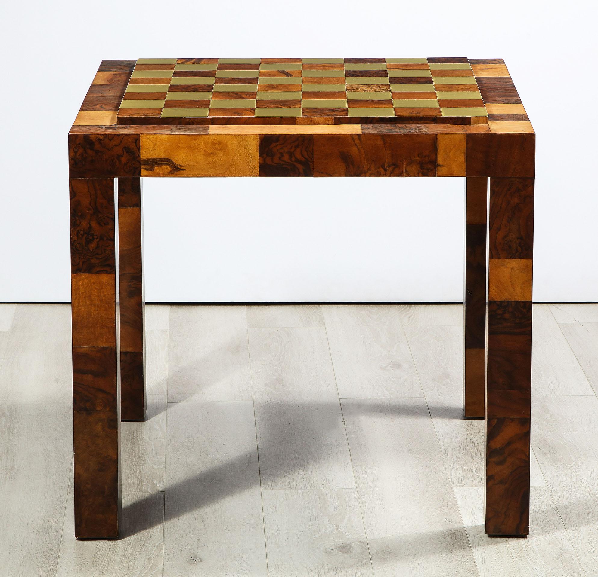 The game table by Paul Evans, having a burl wood frame supporting a top which reverses from a polished brass and burl board to a black laminate top or it can be removed to use the felt base underneath.