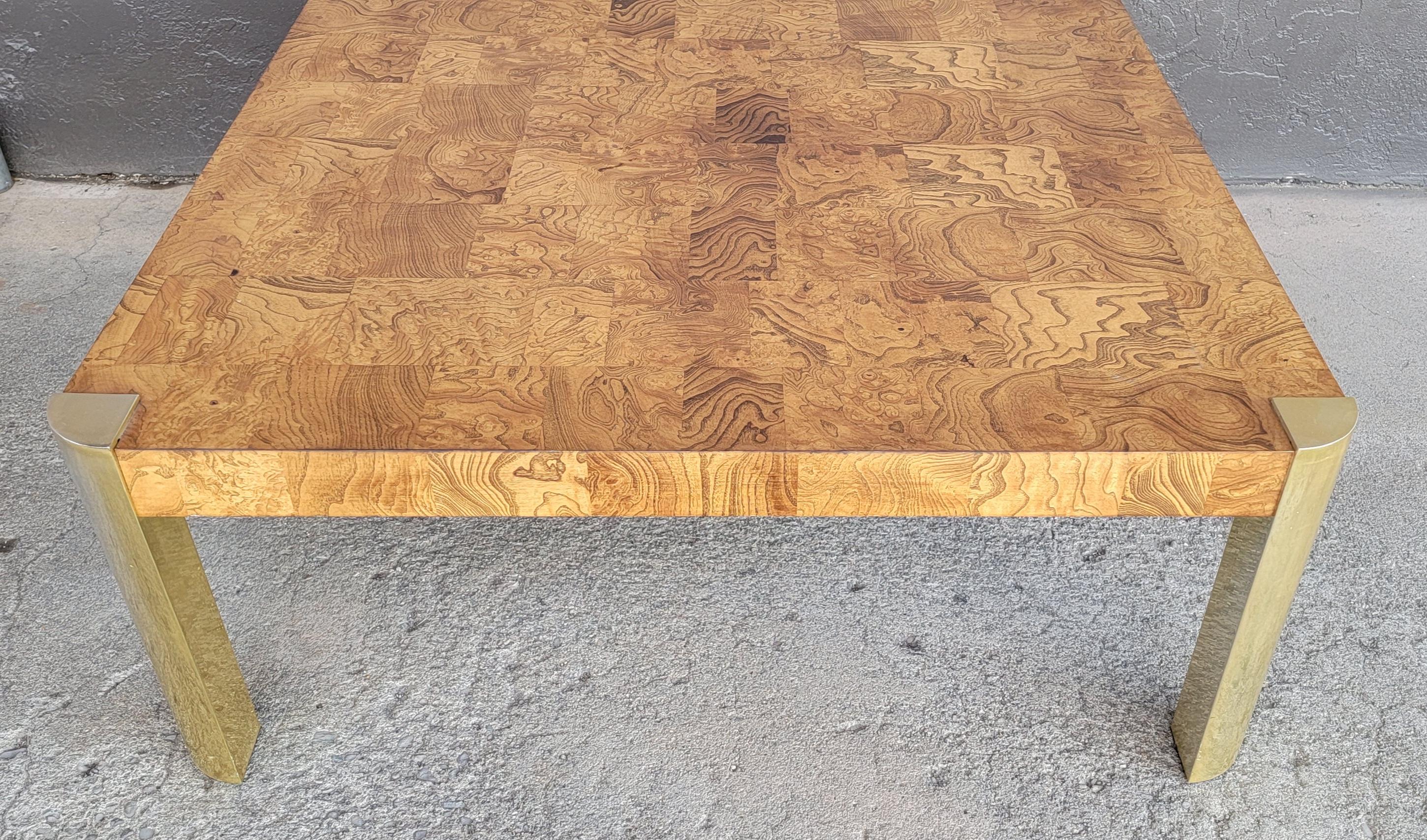 Patchwork Burl wood and brass square coffee table attributed to Milo Baughman. Possibly inspired by the designs of Paul Evans. Exotic burl wood tile surface and apron mounted to brass legs. Measures 38 inches square.