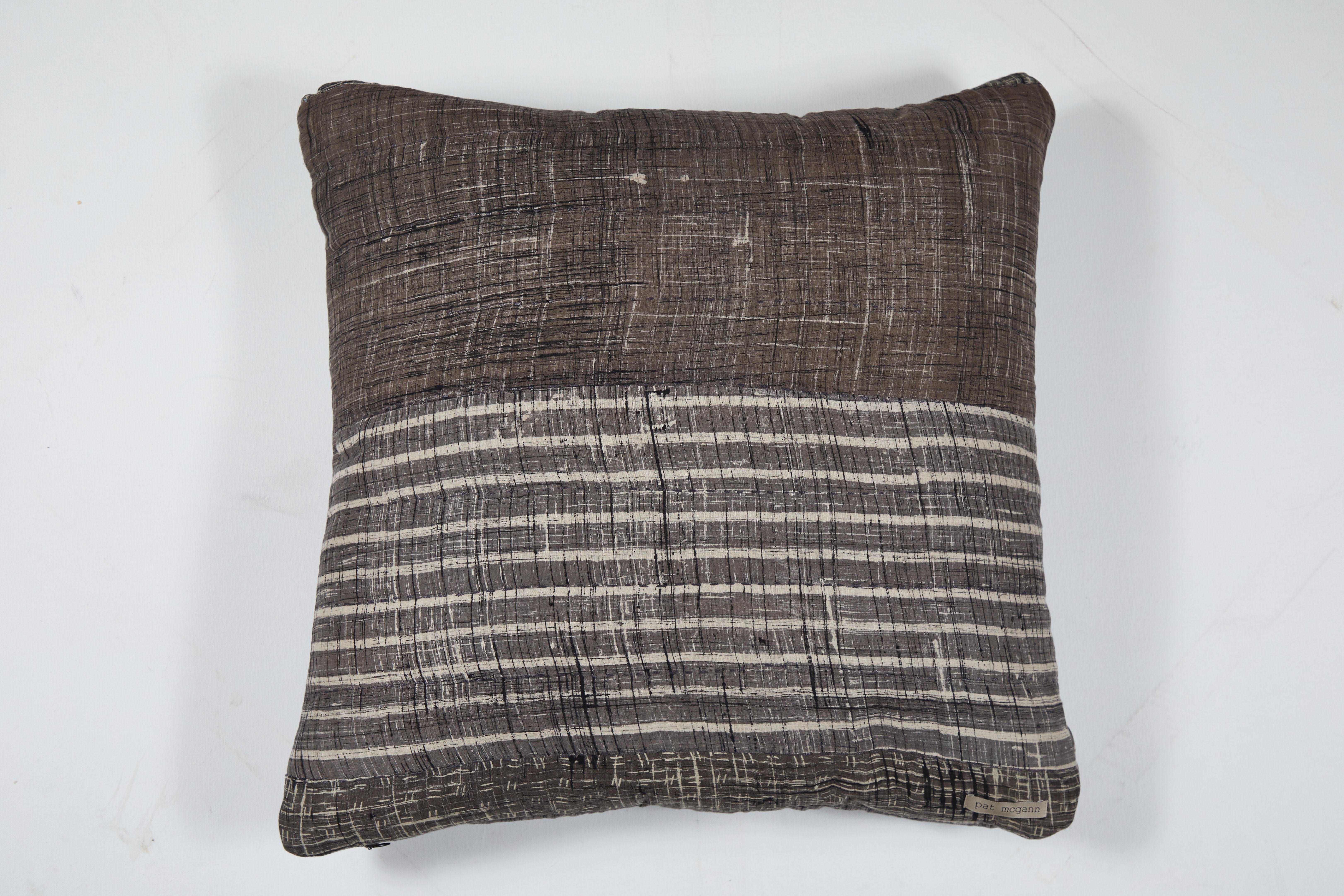 Double sided pillow made from hand painted, block-printed and over dyed Indian cotton. All-over quilting stiches on patchwork. Handmade therefore each piece varies slightly. Invisible zipper closure and feather and down fill. 

 