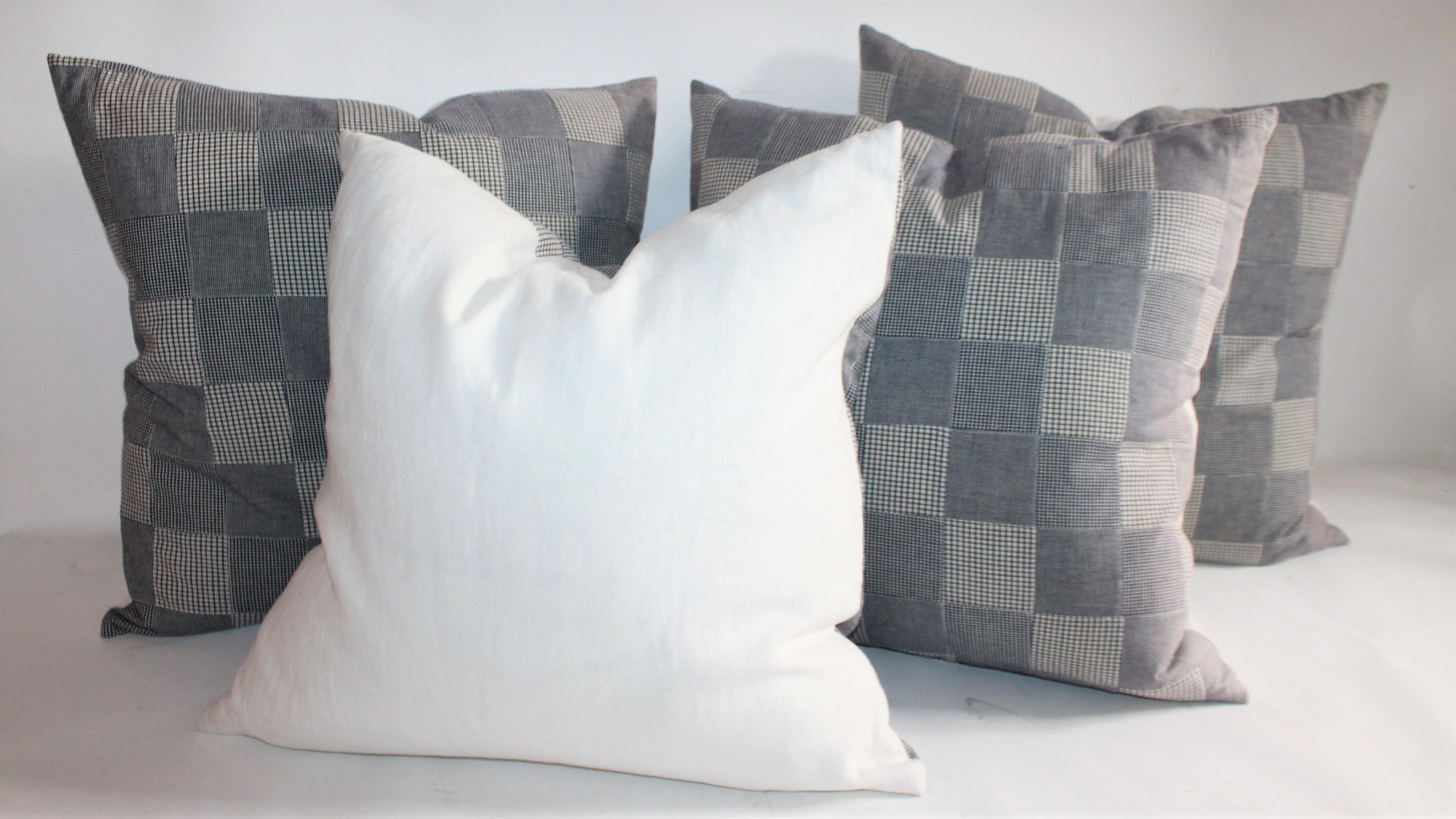 These patch work pillows are small square patches of blue and white check fabric. Collection of four pillows - two pairs.