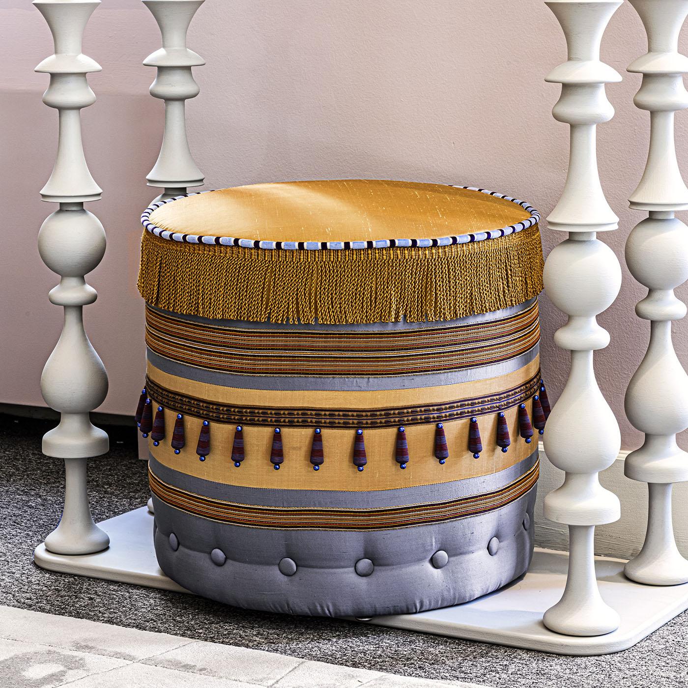 This handcrafted round pouf with patchwork design exemplifies exquisite artistry. Made of precious textiles brings a unique touch to any home décor.