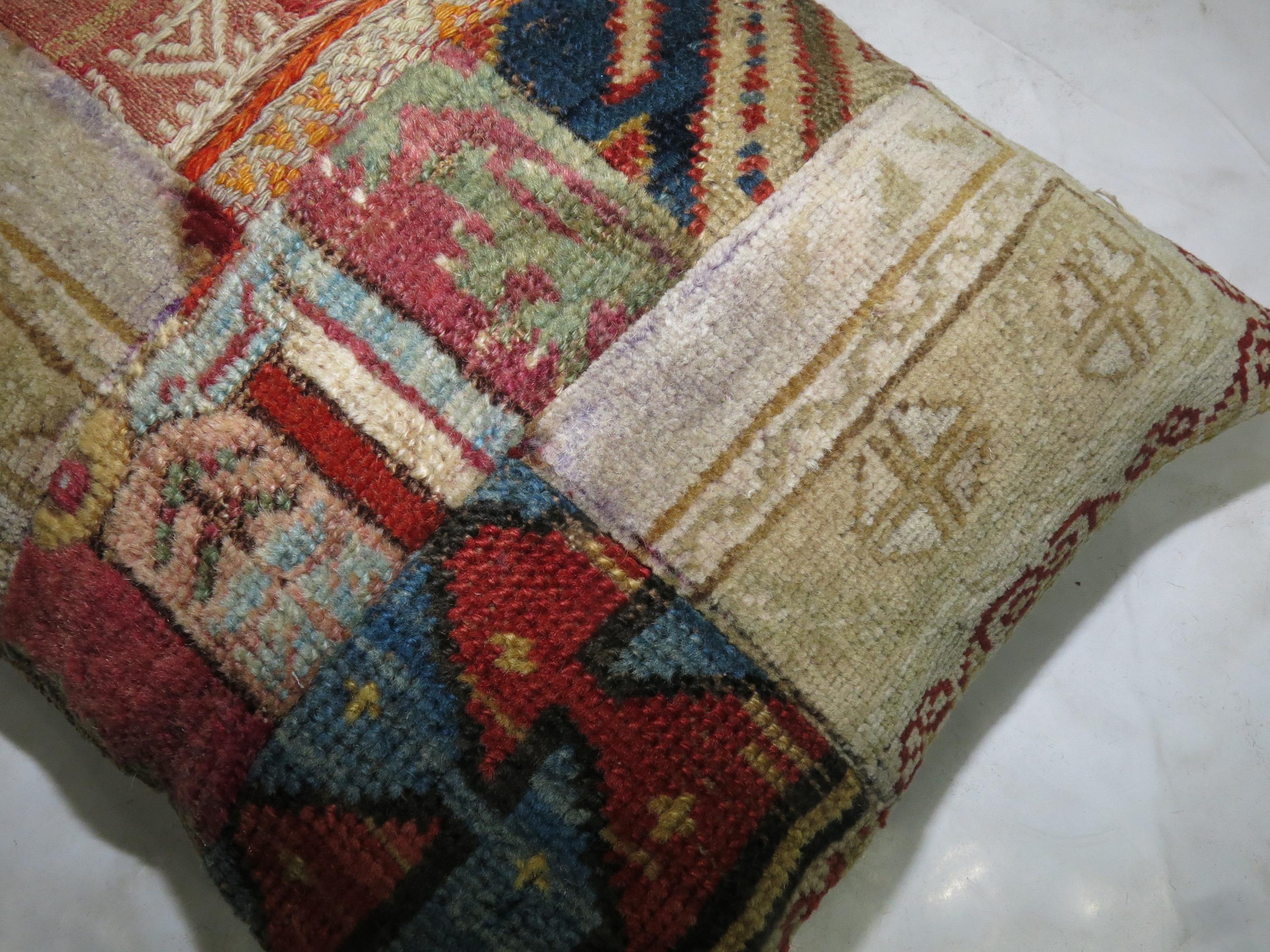 Pillow made from an assortment of antique Persian and tribal Caucasian rugs.

16'' x 19''