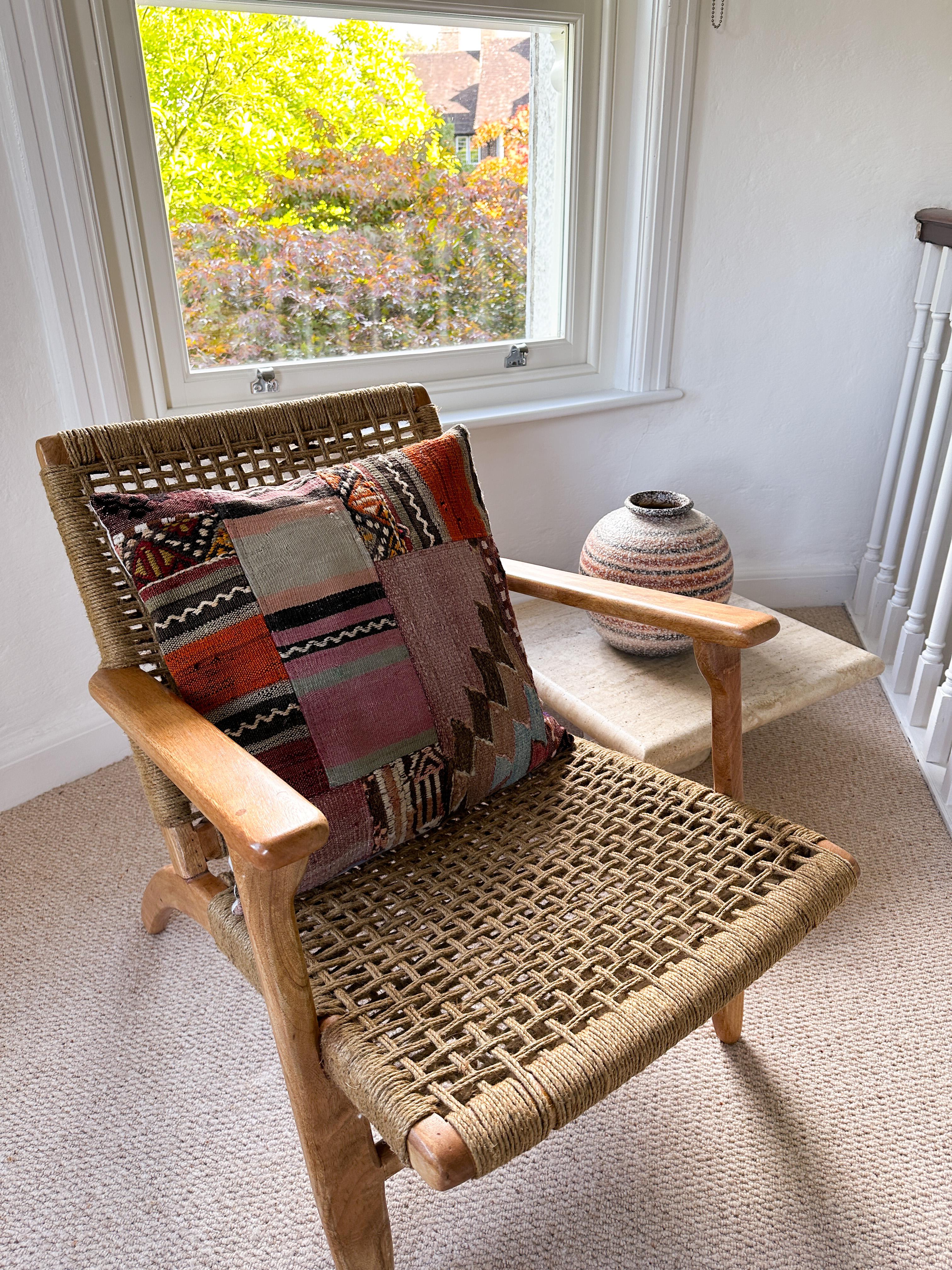 Luxury pillow created from an exquisite piece of vintage kilim rug combined with Irish Linen by Irish designer Katie Larmour. Unique and one-of-a-kind. 

In rich, warm, dramatic stripes of orangey rust red and soft black. 
The pieces of woollen rug