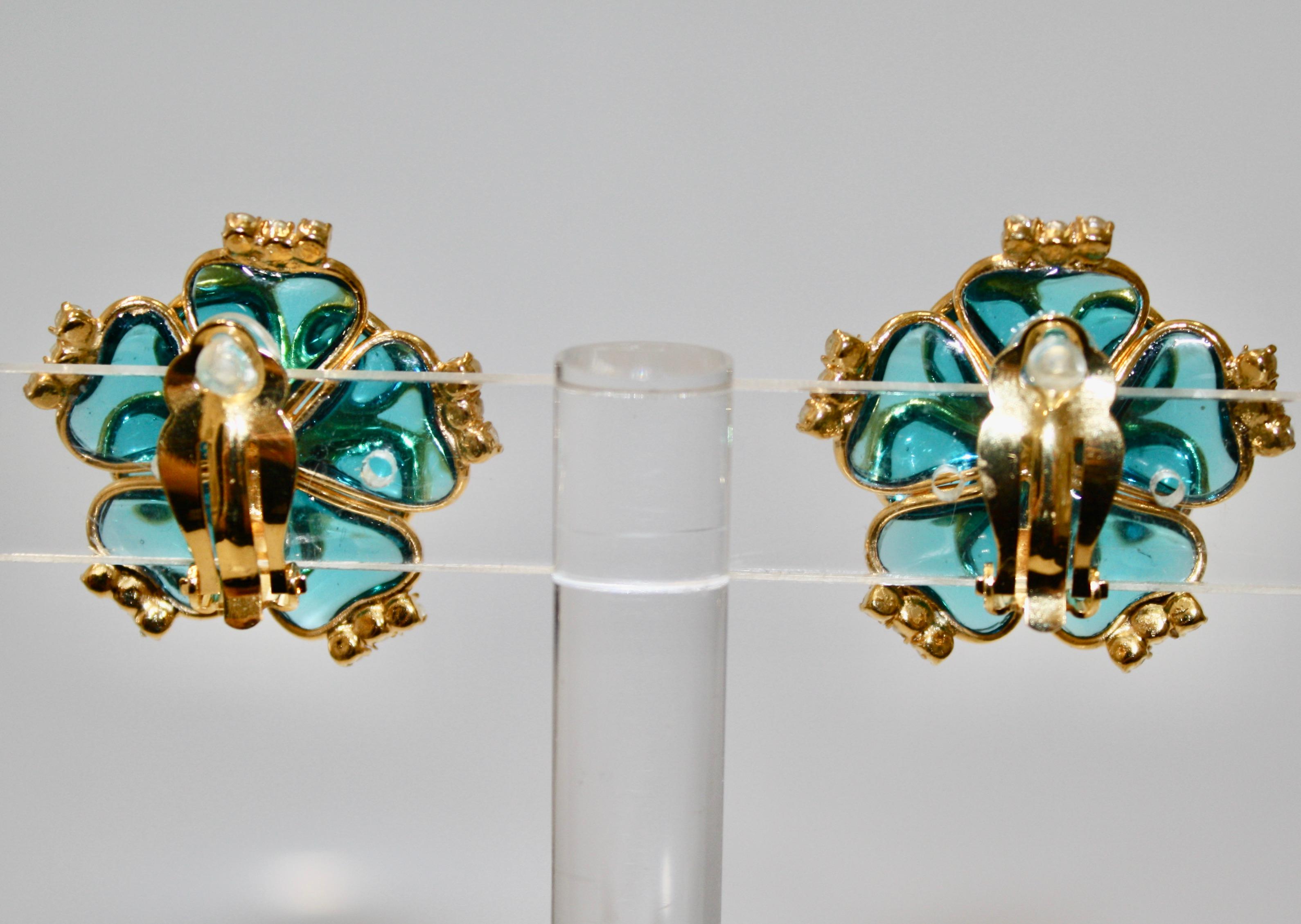 Made by the former artisans of the House of Gripoix. Handmade glass pearls and aqua tinted poured glass. A process used for the house of Chanel. Gilded brass metal.