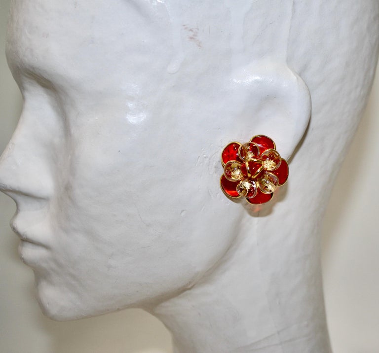 Designed  by the former artisans of the atelier of Gripoix, made in the special process of pate de verre or poured glass. Gold leaves are inserted in the glass. 18-carat gilded brass. Clip earrings