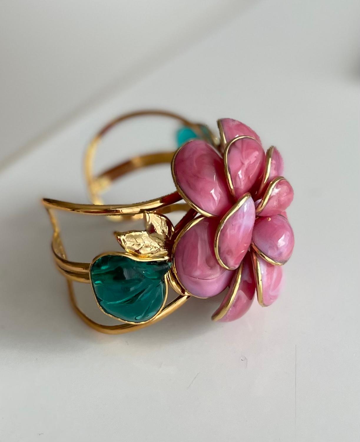 Camellia flower cuffmade in Pate de verre or poured glass, a process used by the House of GRIPOIX for many Couture  Houses, especially Chanel.
This piece is designed by a former artisan of the House of GRIPOIX.  The cuff is flexible, opening is 1”,